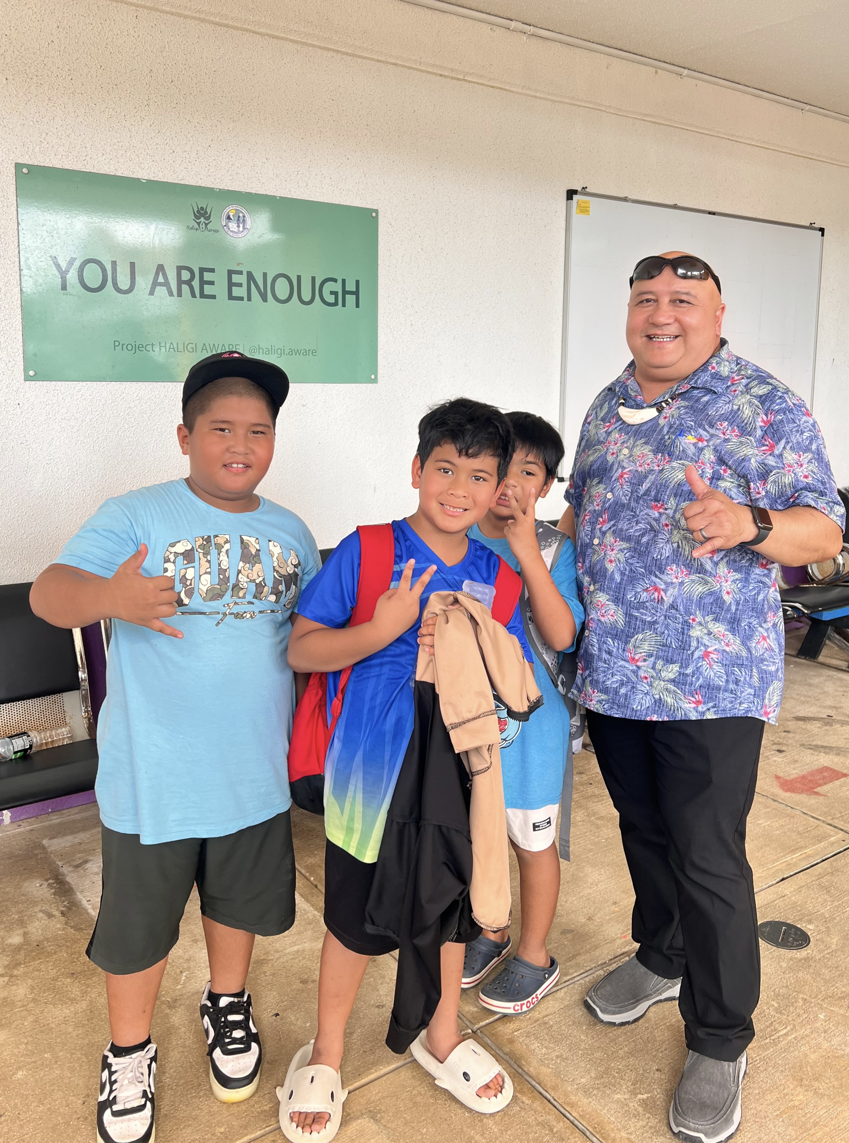 Kagman Elementary School students celebrate with Commissioner of Education Dr. Lawrence F. Camacho.