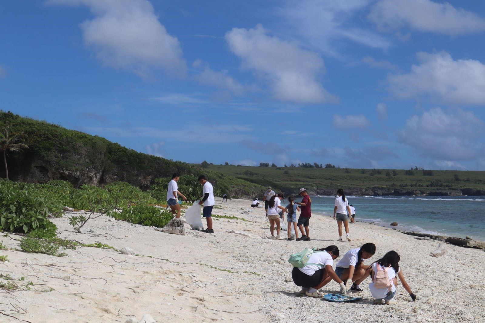 Cadets pick up trash along the shore.