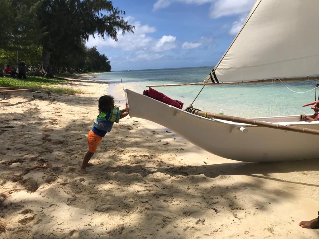 A child pushes a canoe.  The next decade begins.