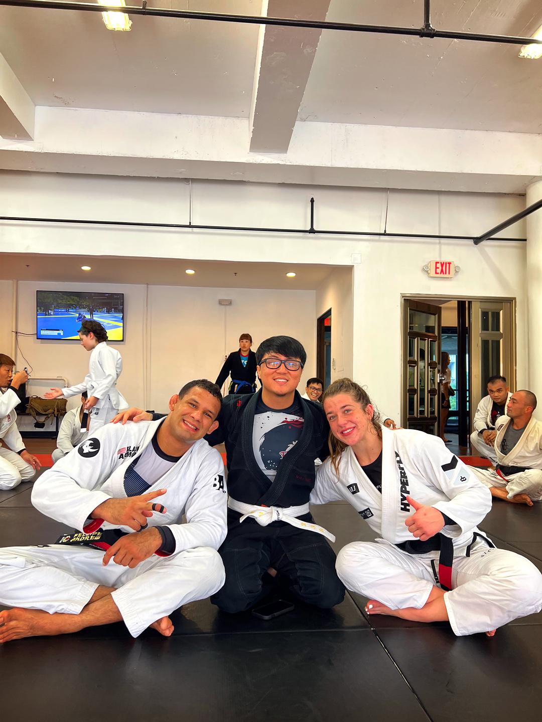Ballen Song, center, poses with world champions Felipe Andrew and Leticia Cardozo.