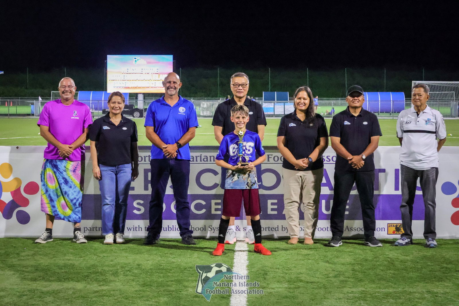GES 1’s Evan Poole holds the MVP award as he poses for a photo with NMIFA officials during the awards ceremony for the co-ed elementary school division of the PSS-NMIFA Interscholastic Soccer League SY24-25 at the NMI Soccer Training Center on Thursday.