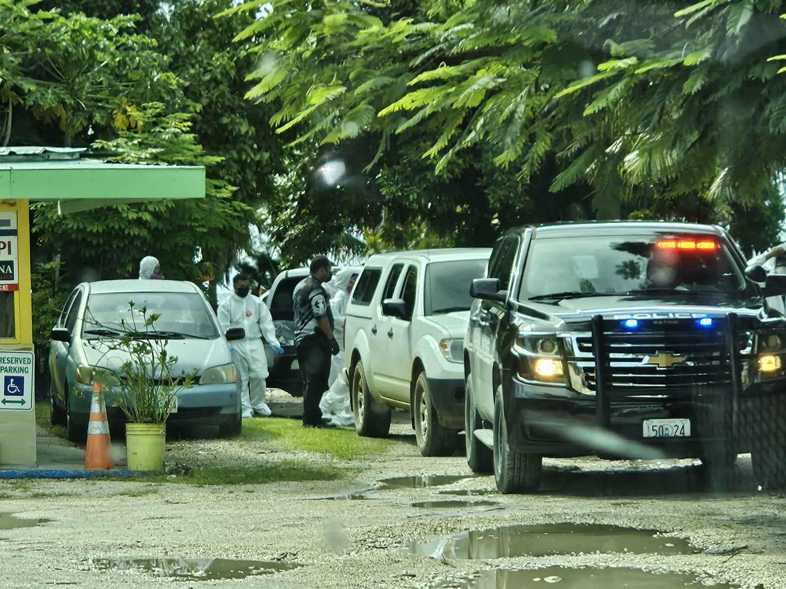 Department of Public Safety-Crime Scene Unit officers are seen at JTM Snack Bar & BBQ Grill in Garapan on Sunday.