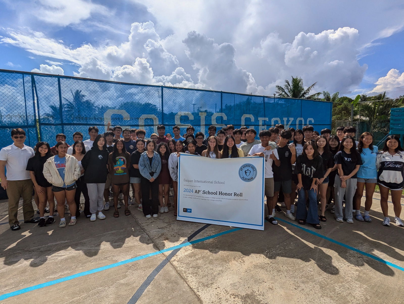 Saipan International School’s current AP students pose for a photo with a banner with the AP Honor Roll Certificate. Holding the banner are Christian Newman and MJ Magno, the school’s top AP score recipients for 2024.