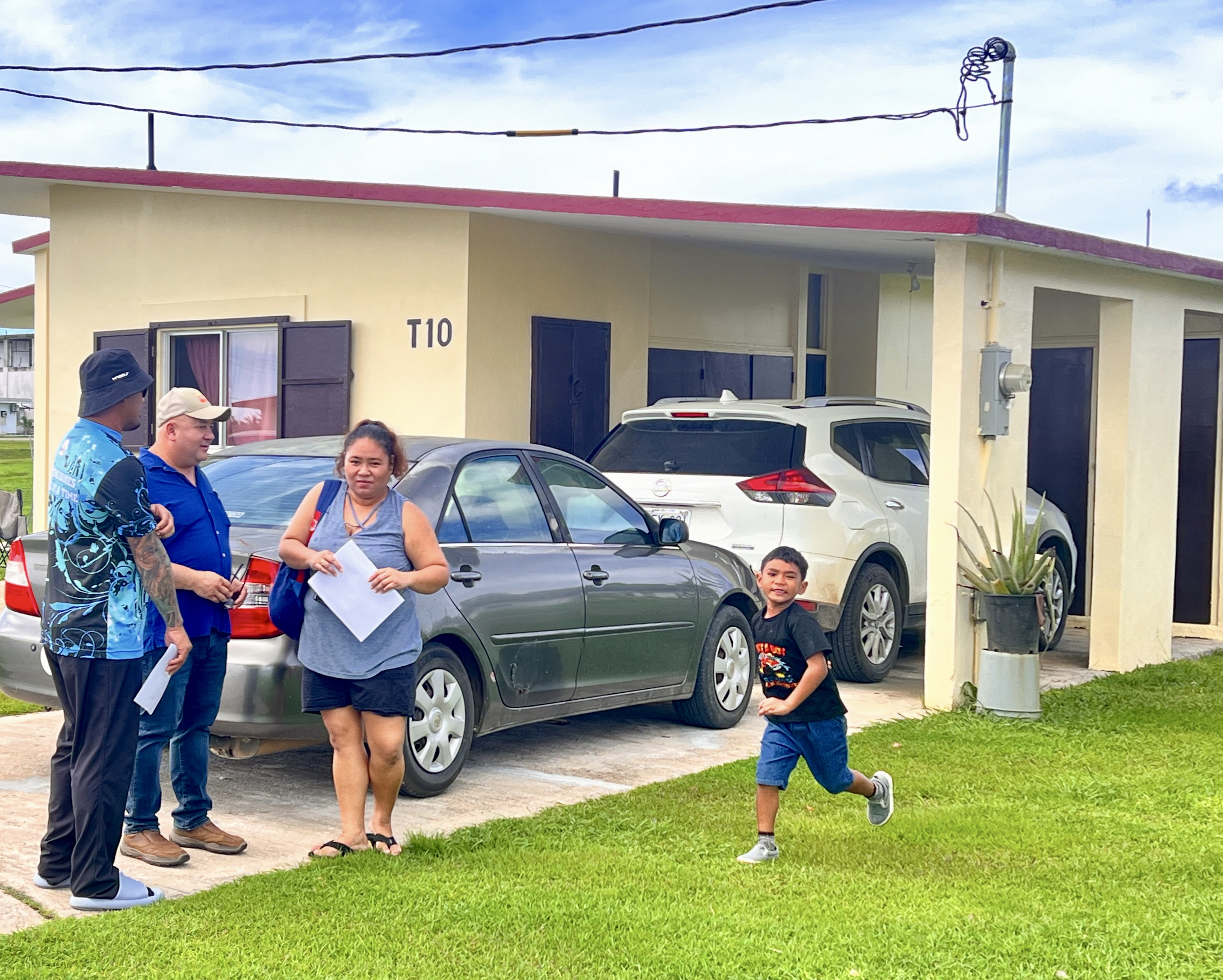 Vanna Aldan, mother of six-year-old Zayn, a first-grade student at Tinian Elementary School, is visited by Commissioner of Education Dr. Lawrence F. Camacho and Early Intervention Program special instruction teacher Peter Mendiola on Tinian, Oct. 16, 2024. Aldan acknowledges how the PSS Early Intervention Program has helped ensure her son receives all the necessary early childhood development support from the Public School System.  