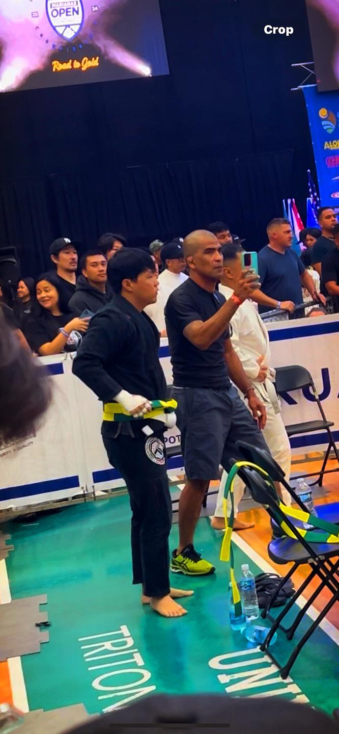 Ballen Song and coach Cuki Alvarez strategize before a match. 