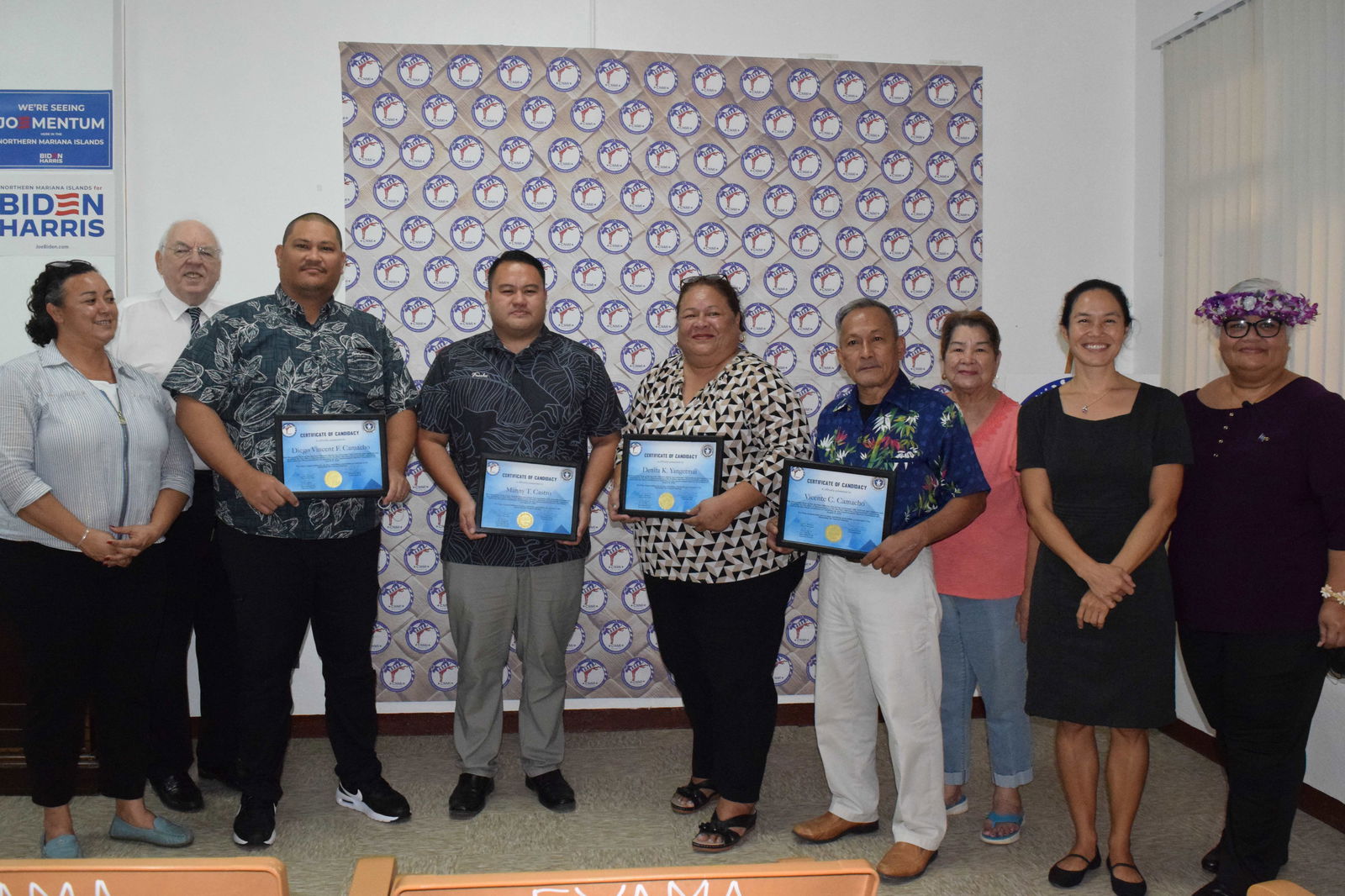 The NMI Democratic Party's senatorial candidate, Rep. Manny Gregory T. Castro, fourth left, House candidates Rep. Diego Vicent F. Camacho, third left, Rep. Denita Yangetmai, center, and Rep. Vicente Camacho, 4th right, pose for a photo with party officials at their headquarters on Wednesday.