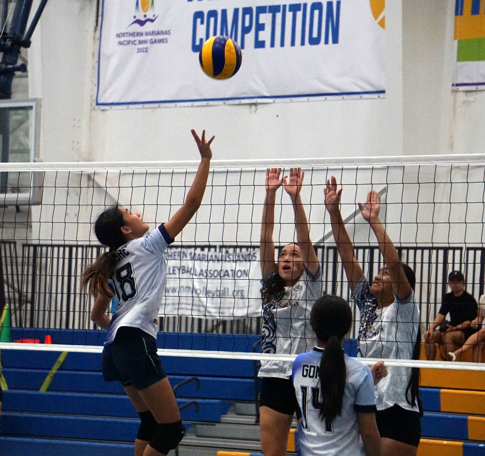 GCA’s Beatrice Fabre tips the ball over two MHS defenders during the girls high school division title match of the PSS-NMIVA Interscholastic Volleyball League SY24-25 at the MHS gym on Tuesday. 