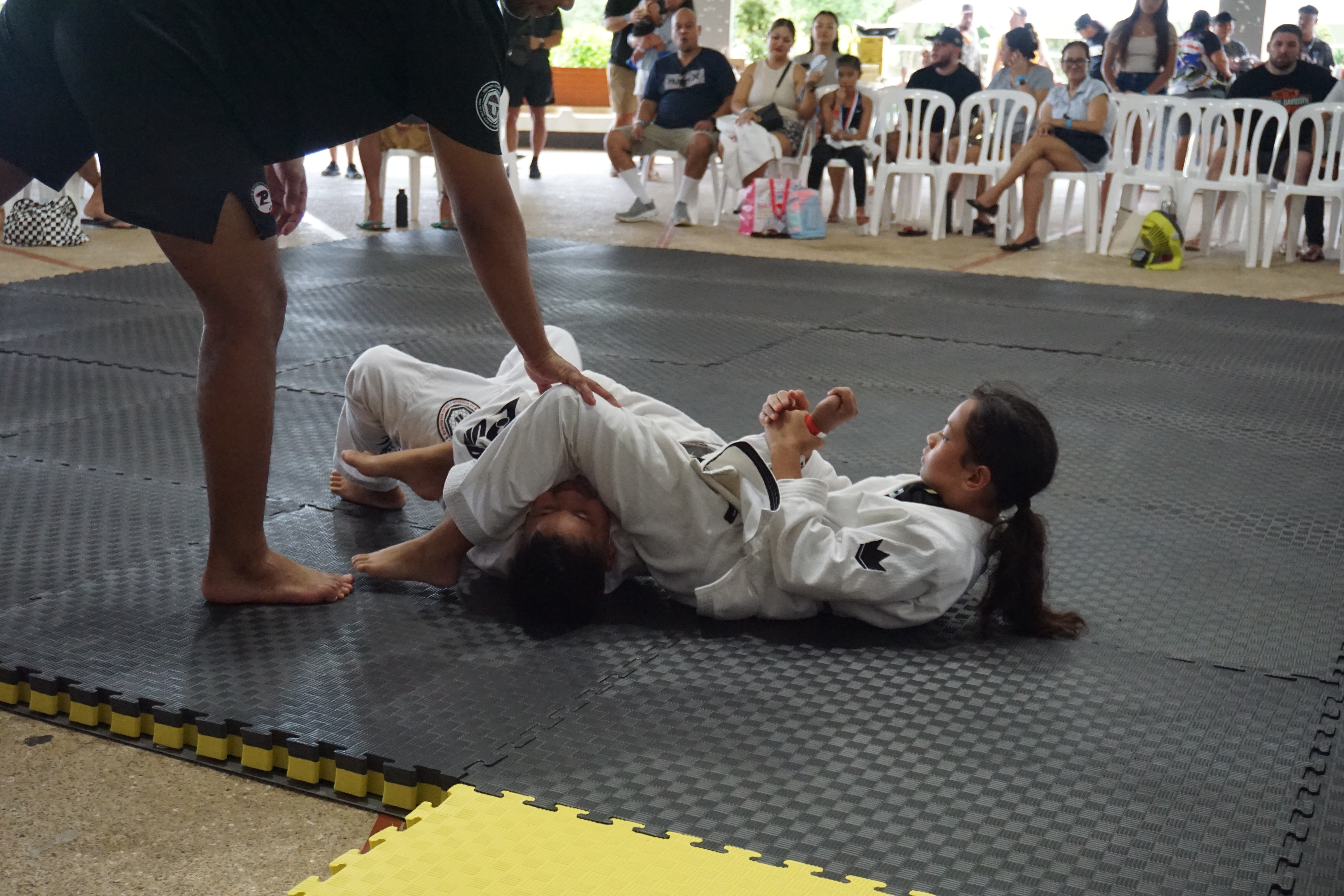 Kaiya Pangelinan locks in the armbar to secure the gold medal. 