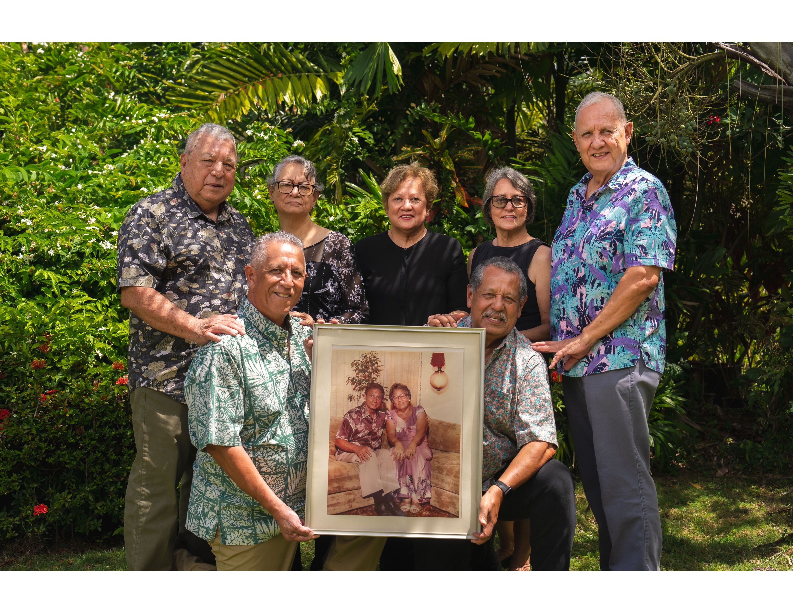 The present generation of the Guerrero clan that now runs the 80-year-old company holds up a photograph of the company's founders, Herman R. and Maria T. Guerrero.