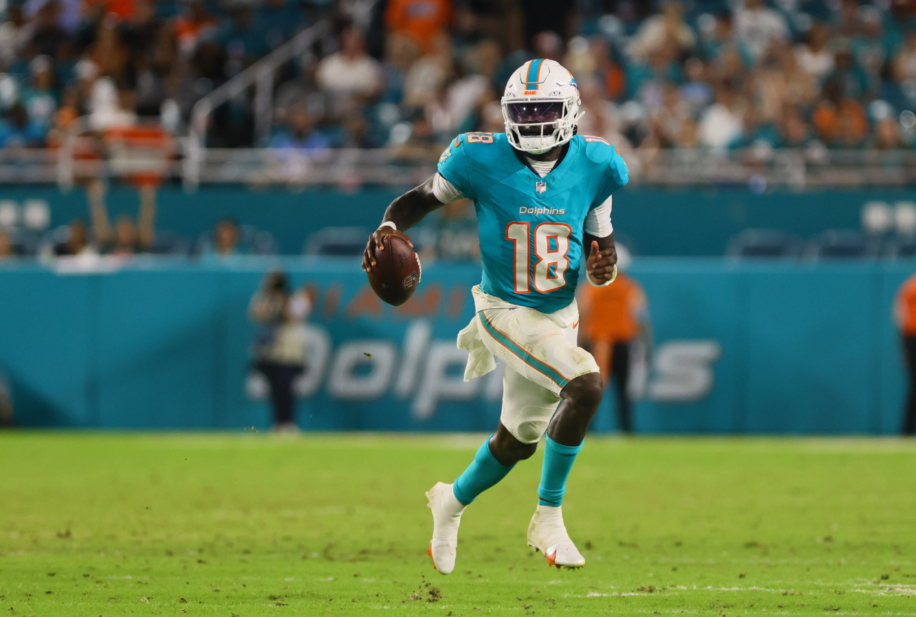 Miami Dolphins quarterback Tyler Huntley (18) runs with the football against the Tennessee Titans during the fourth quarter at Hard Rock Stadium in Miami Gardens, Florida, Sept. 30, 2024.