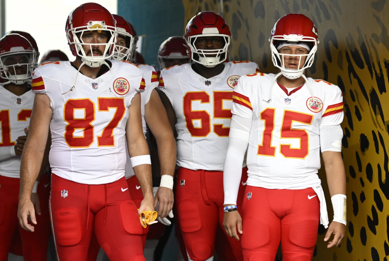 Kansas City Chiefs’ quarterback Patrick Mahomes (15) and tight end Travis Kelce (87) wait to lead their team onto the field before a preseason NFL game against the Jacksonville Jaguars in Jacksonville, Fla. on Aug. 10, 2024.
