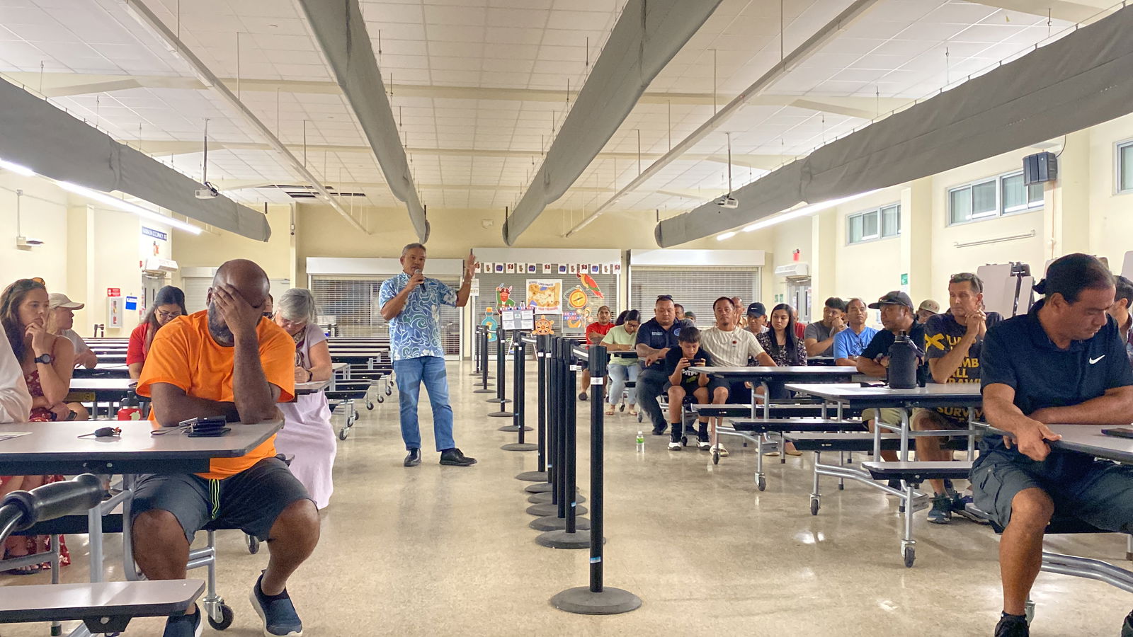 Alex Sablan speaks at the public hearing for Micronesian Air Connection Services' QC application.