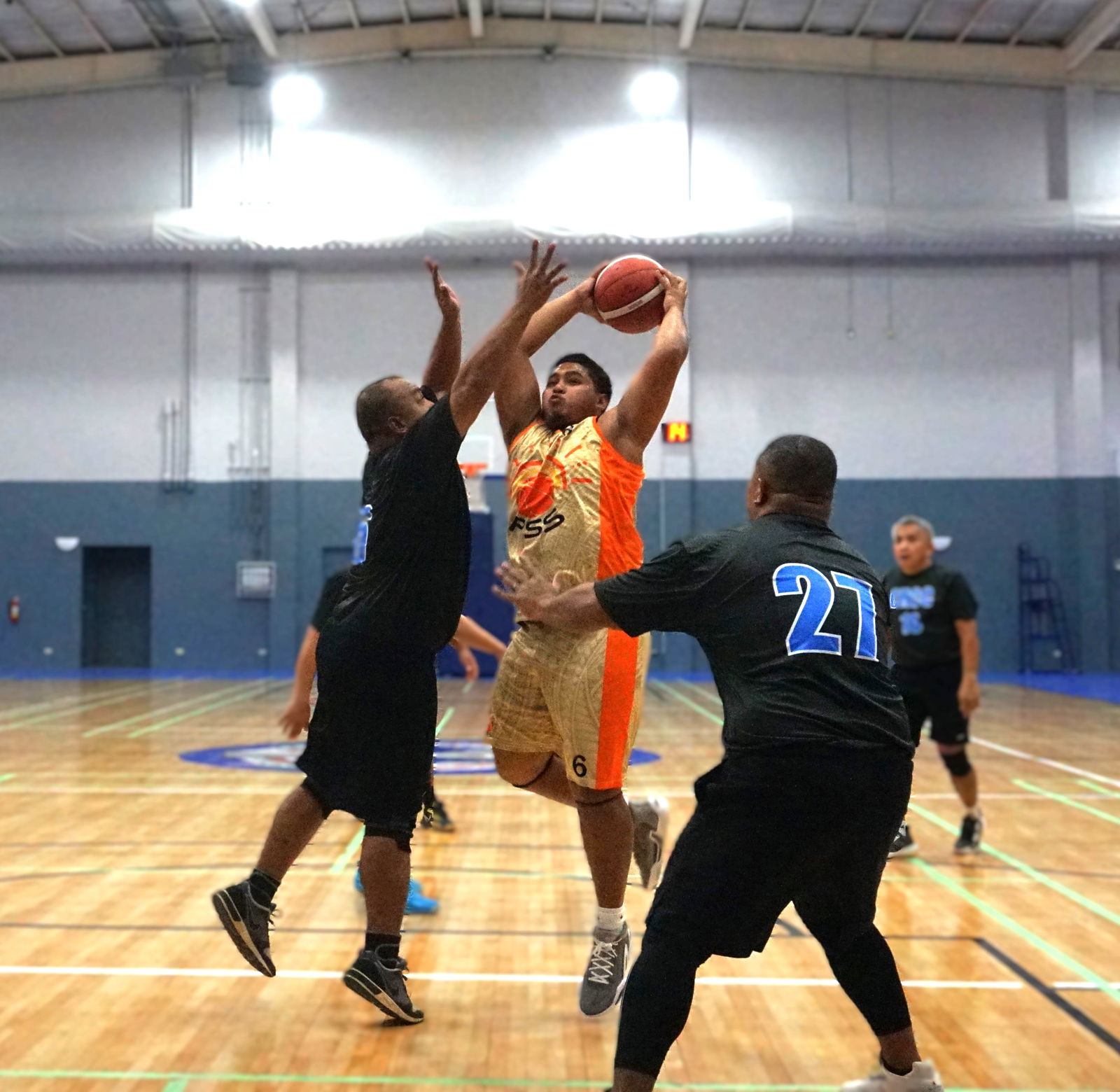 PSS' Tyrik Basa attempts to drive toward the hoop against two CHCC defenders during a game of the 2024 R&J Wine and Liquor Inter-Government/Business League at the Ada gym on Tuesday. 