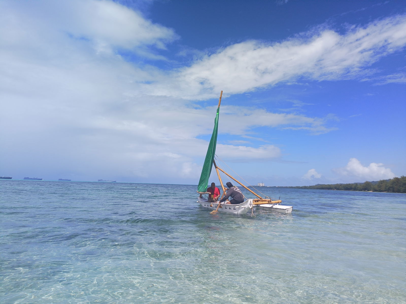 Den Yo Povi, piloted by her owner, Jeremiah Benavente, sails in front of the Guma Sakman on her launch day. 