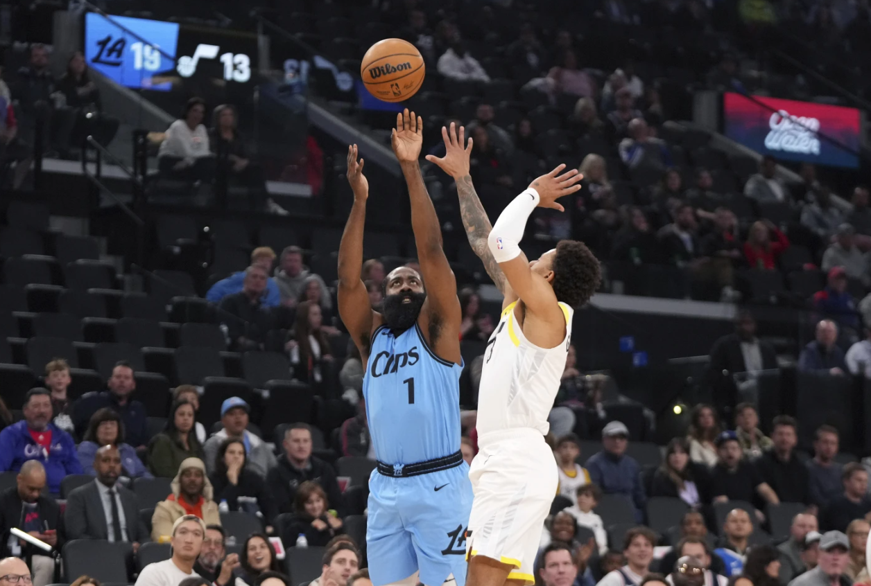 Los Angeles Clippers guard James Harden, left, shoots as Utah Jazz guard Keyonte George defends during the first half of an NBA game, Sunday, Nov. 17, 2024 in Inglewood, Calif.