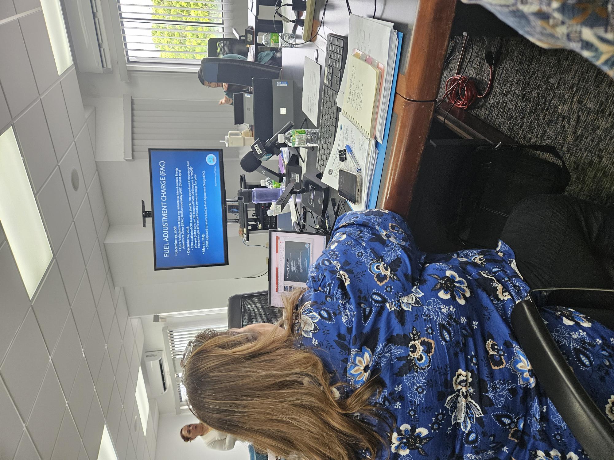 Commonwealth Utilities Corporation Chief Financial Officer Betty Terlaje, back to the camera, conducts a presentation regarding the Fuel Adjustment Charge during CUC board meeting on Monday morning.