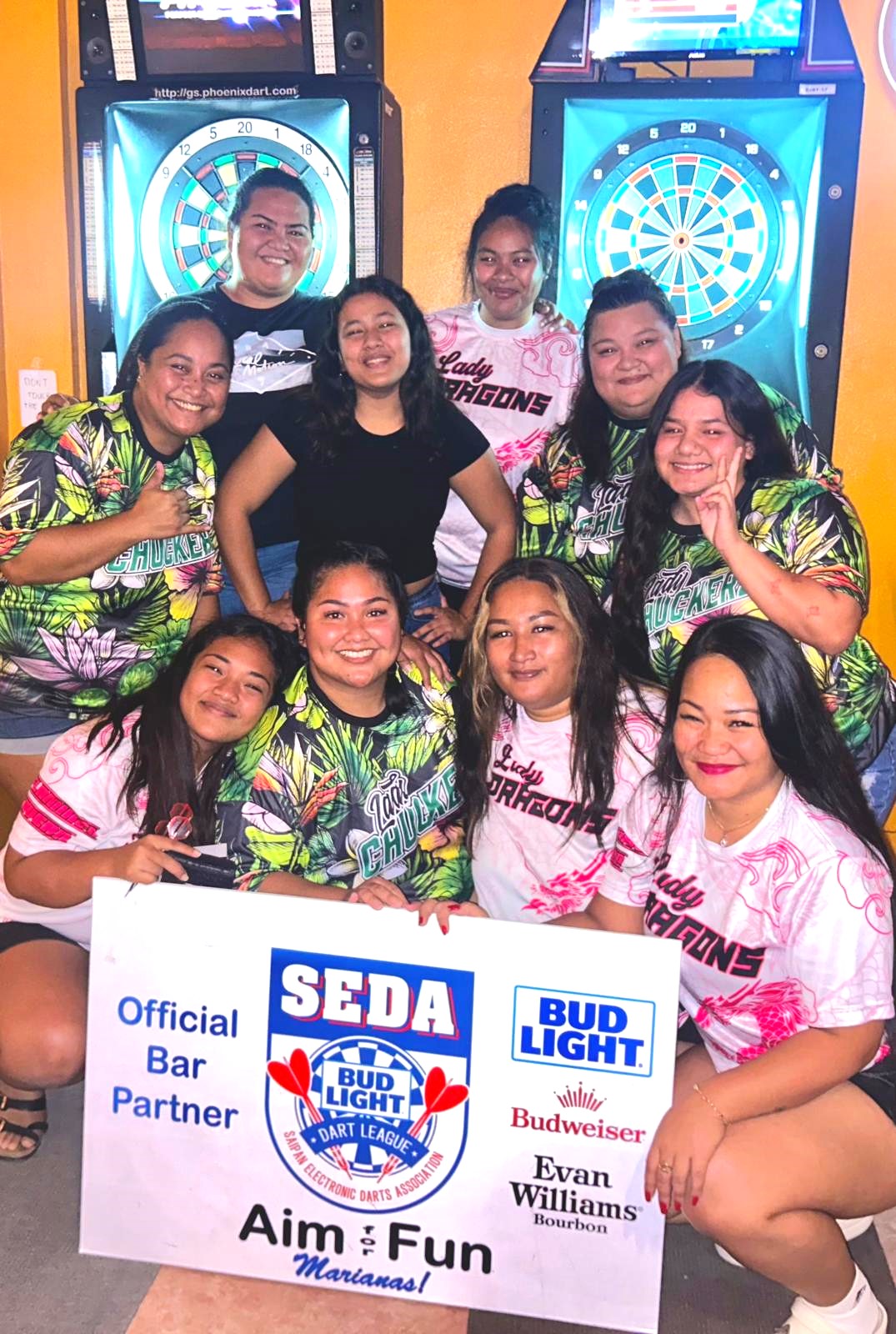 The Flamingo Lady Dragons and TomYum Lady Chuckerz pose for a photo after competing their match in the ladies division of the 2024 SEDA Bud Light Dart League at the TomYum Restaurant on Monday. 