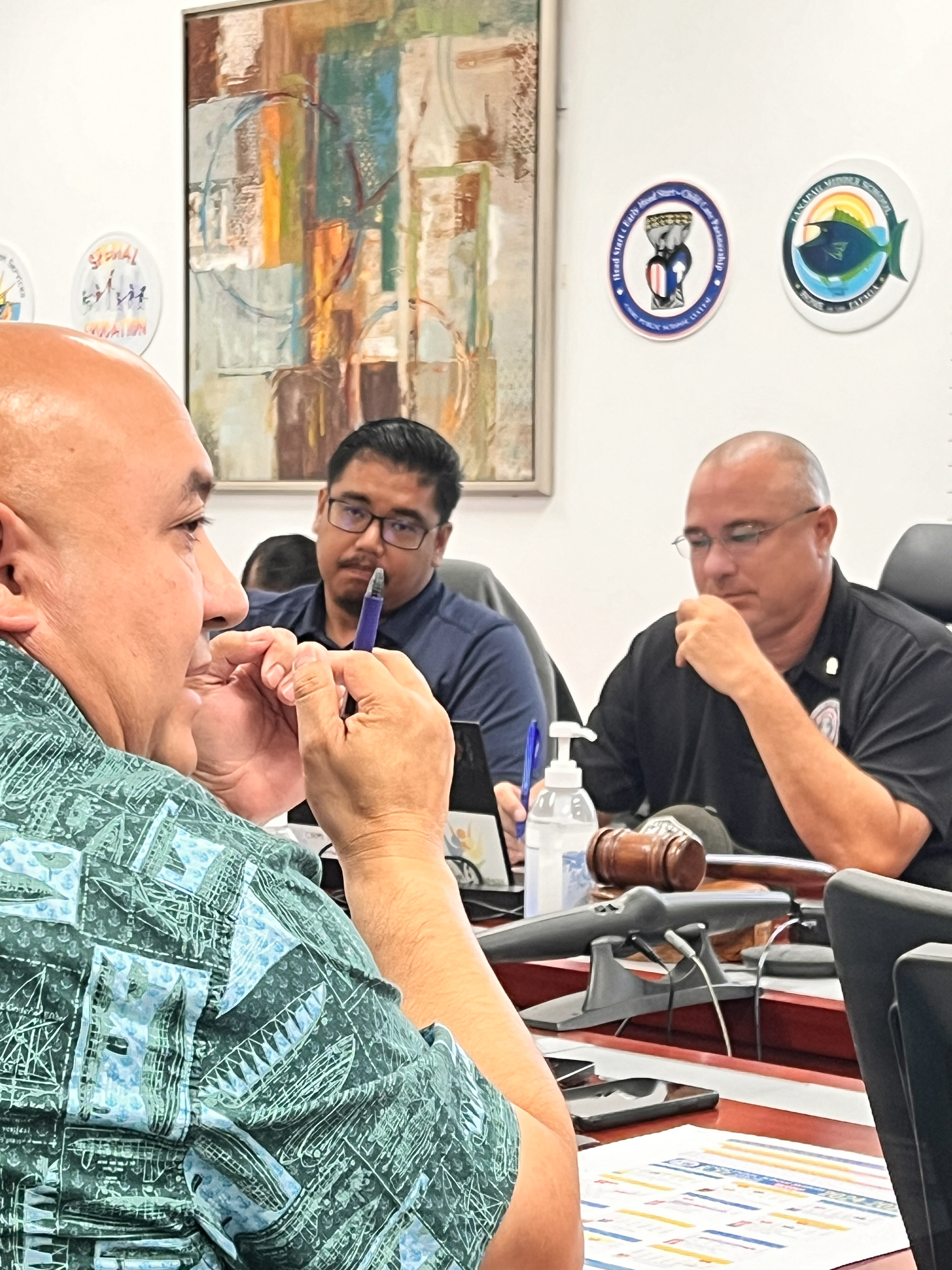 Commissioner of Education Dr. Lawrence F. Camacho, left, speaks as newly elected Board of Education Chair Gregory Pat Borja and BOE member Antonio L. Borja listen.