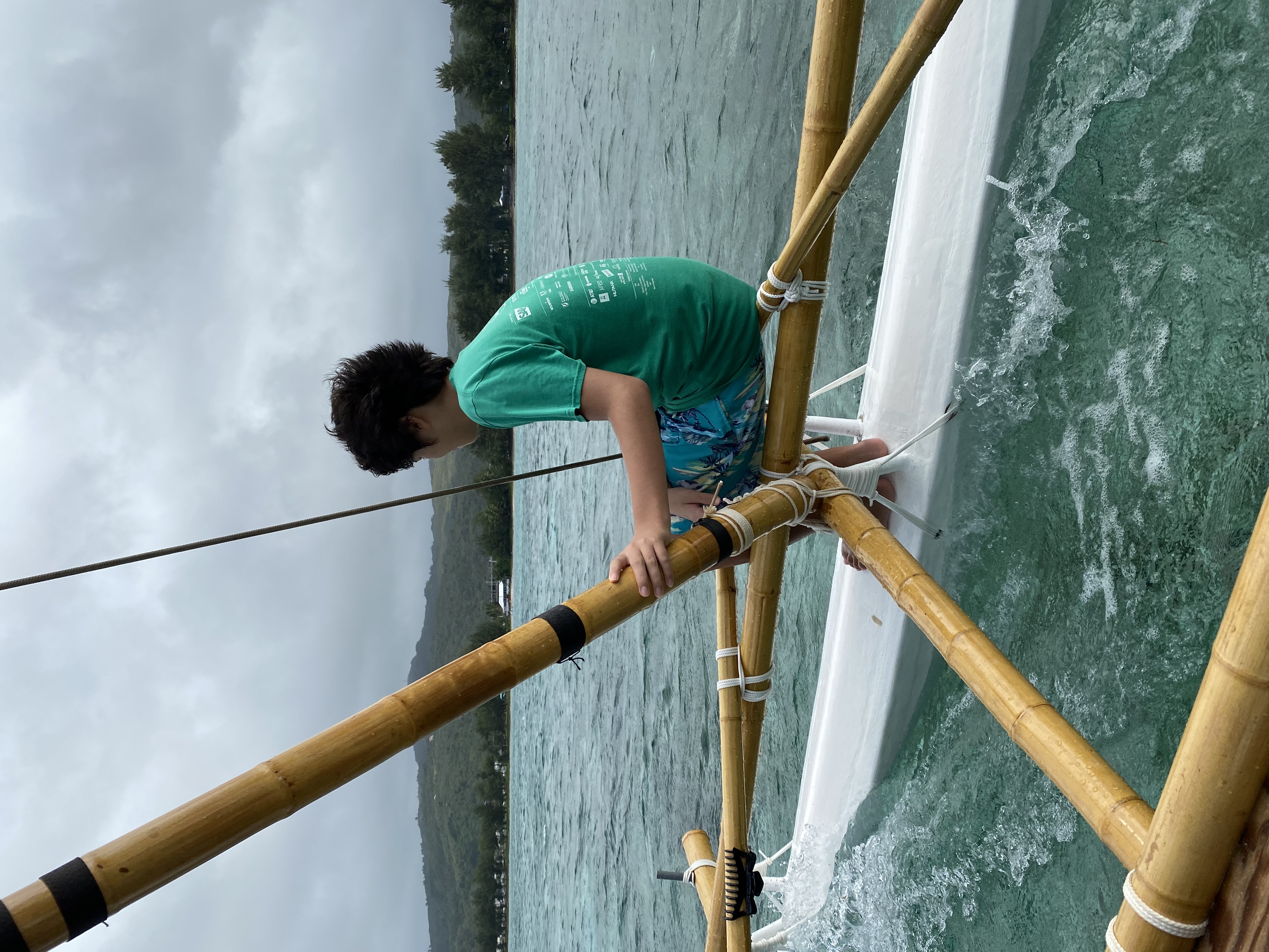 Issac Wright, who at the time was a Lalayak student, sits aboard the lucha, or outrigger of one of the canoes in 500 Sails' fleet. 500 Sails aims to continue building the sailing capacity of island residents in the coming years. 