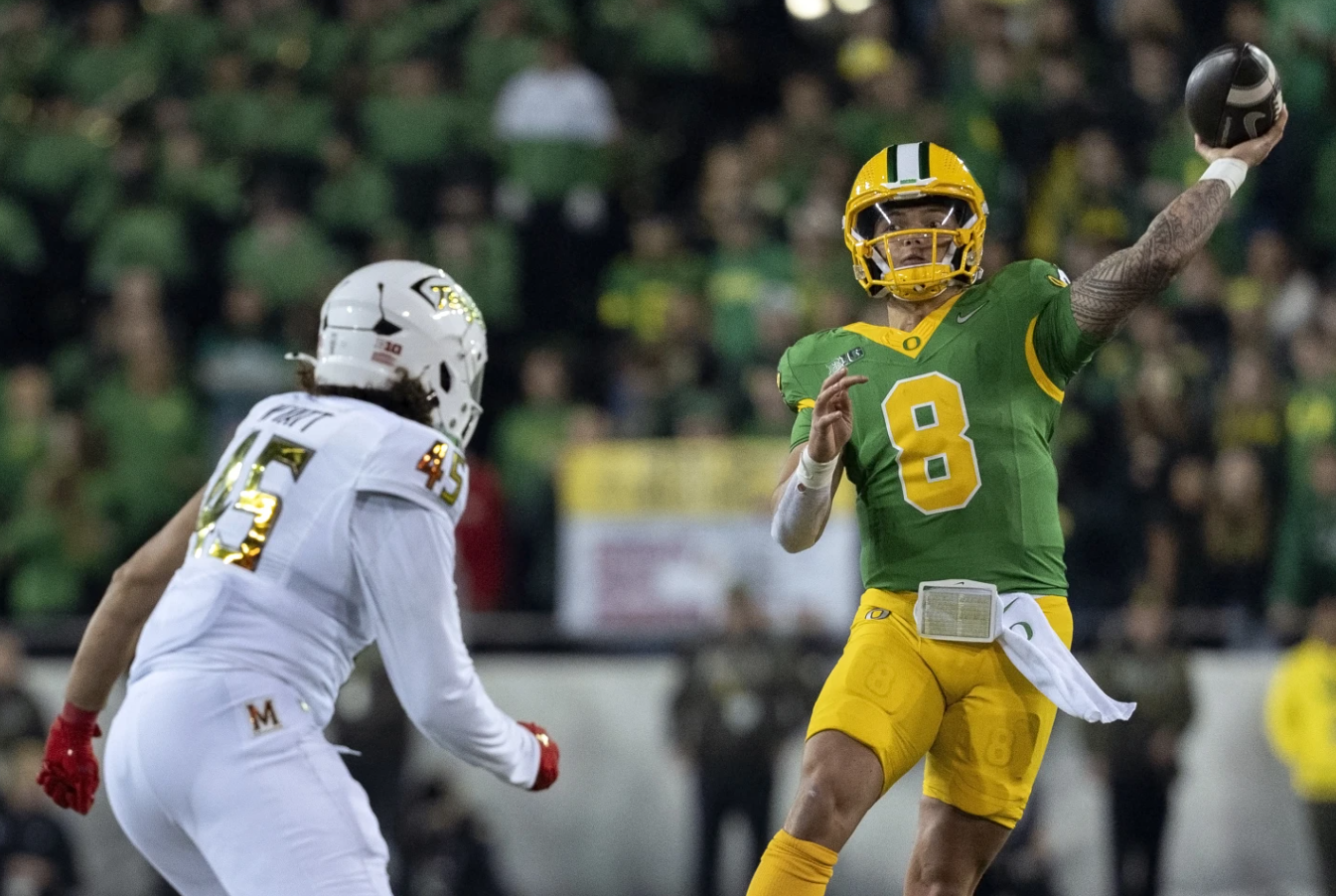 Oregon quarterback Dillon Gabriel throws the ball as Maryland linebacker Kellan Wyatt defends during the second half of an NCAA football game on Saturday, Nov. 9, 2024 in Eugene, Ore. Oregon won 39-18.