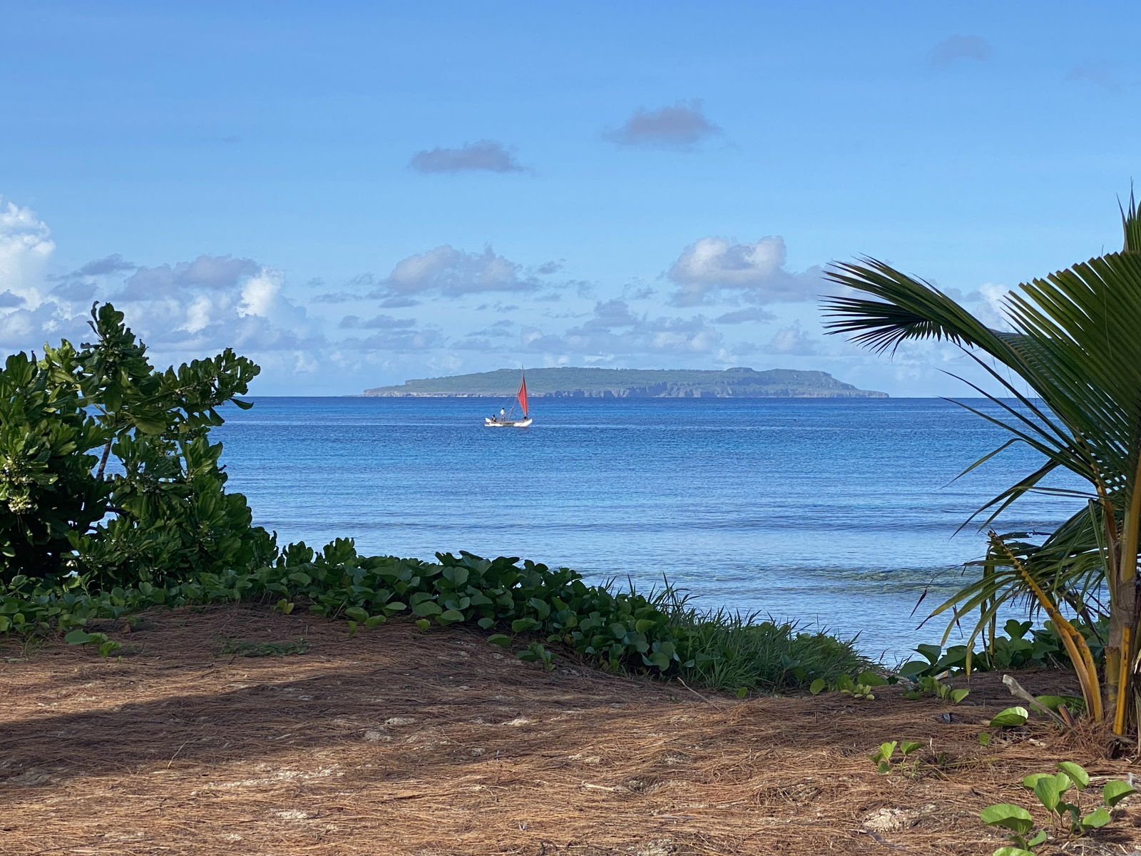 Sails to Tinian provide an exciting first open ocean sailing experience for sailors who have completed the Lalayak program, and serve as an opportunity for 500 Sails to build relationships with Tinian’s community. In this photo, Richard Seman sails through the waters of Tachogna Beach, with Aguiguan in the background.