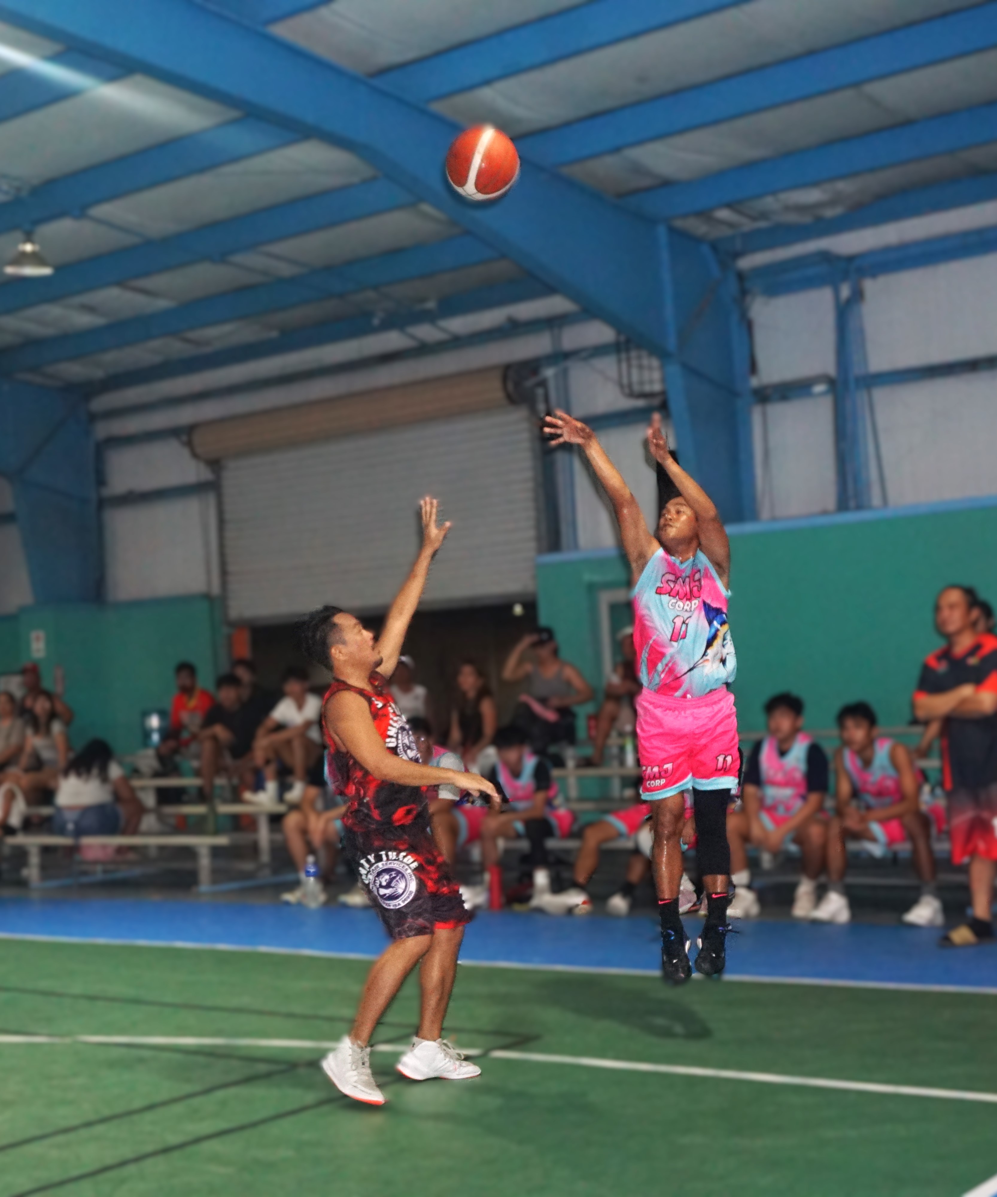 SMJ Corp’s Frank Ferrer takes the contested three-point shot during a playoff game against Unity Trade in the semi open division of the Win Pacific Corporation Invitational Basketball League 2024 at the TSL Sports Complex on Saturday.