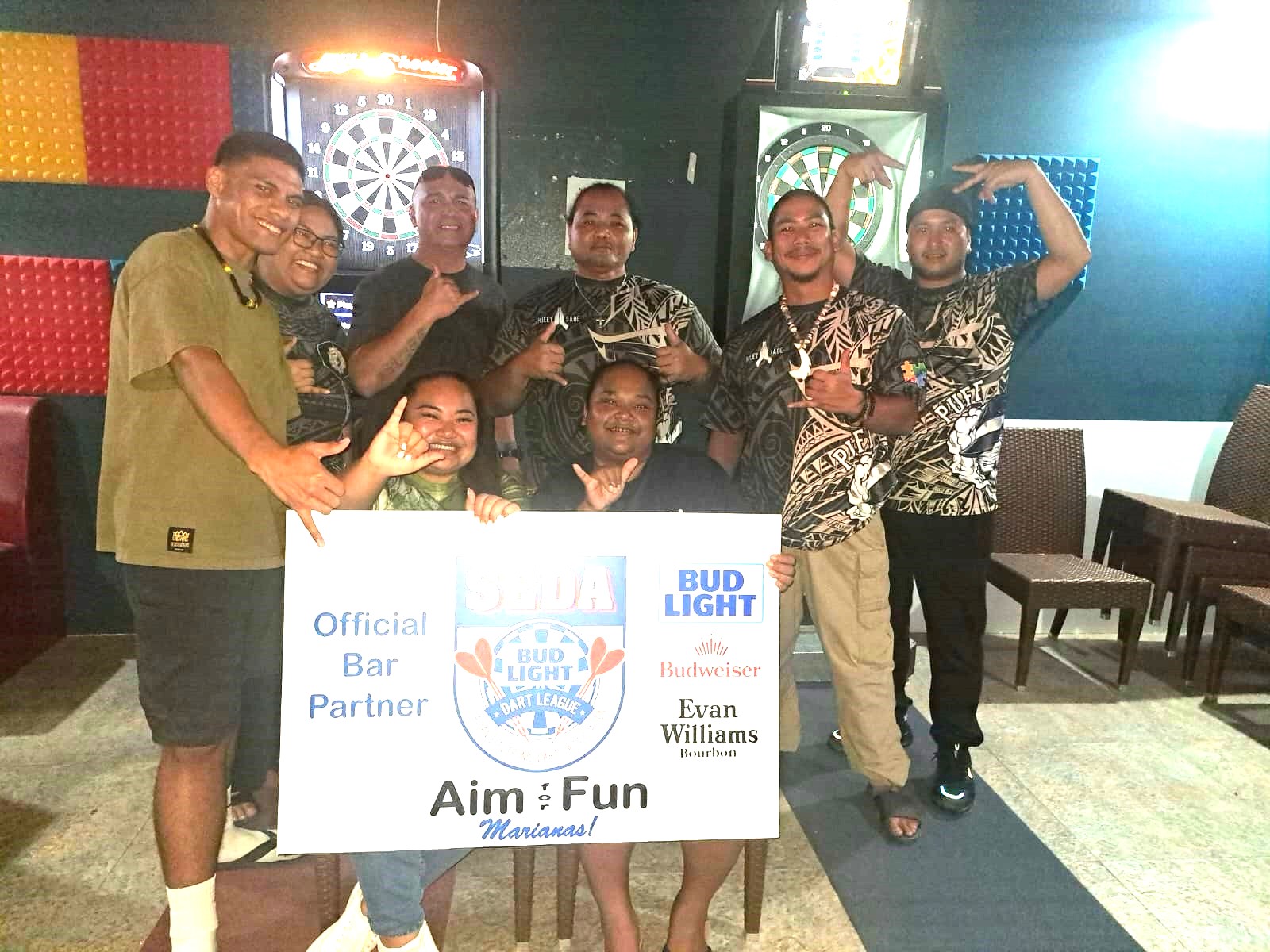 Black 8 Puff Daddy and Tambayan Distorted C players pose for a photo after completing their match in the Kingfisher C division of the 2024 SEDA Bud Light Dart League at the Black 8 Pool Bar on Friday.