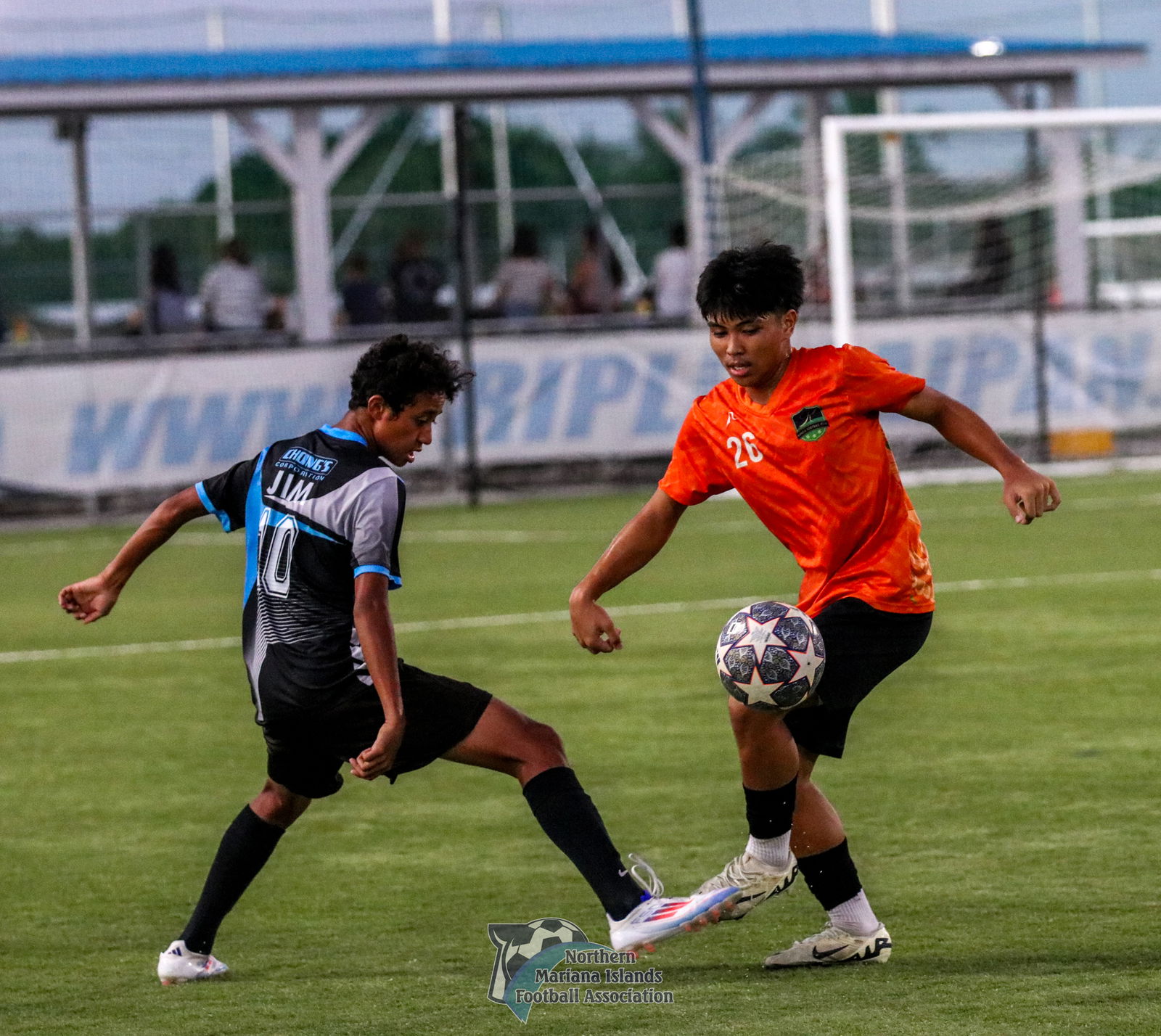Kanoa's Paul Lizama and MPU's Jim Takeru lock legs in a battle for the possession during a U17 boys division game of the TakeCare Youth Soccer League Fall 2024 at the NMI Soccer Training Center on Saturday. 