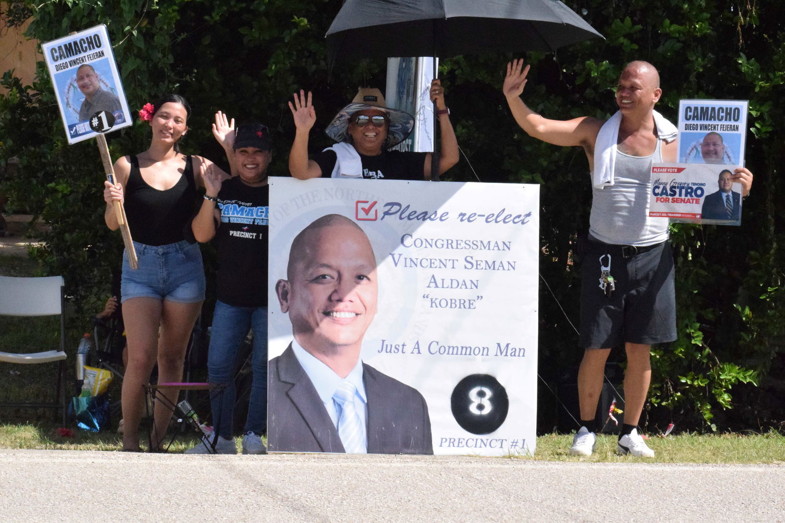 Precinct 1 Rep. Vincent S. Aldan, right, and his supporters wave at motorists on Dandan Road.