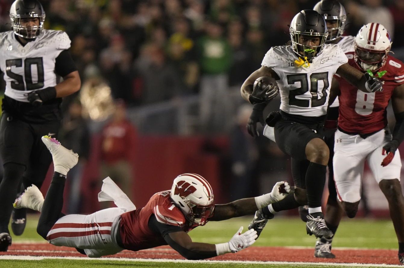 Wisconsin’s Jake Chaney tries to stop Oregon’s Jordan James during the first half of an NCAA game Saturday, Nov. 16, 2024 in Madison, Wis.