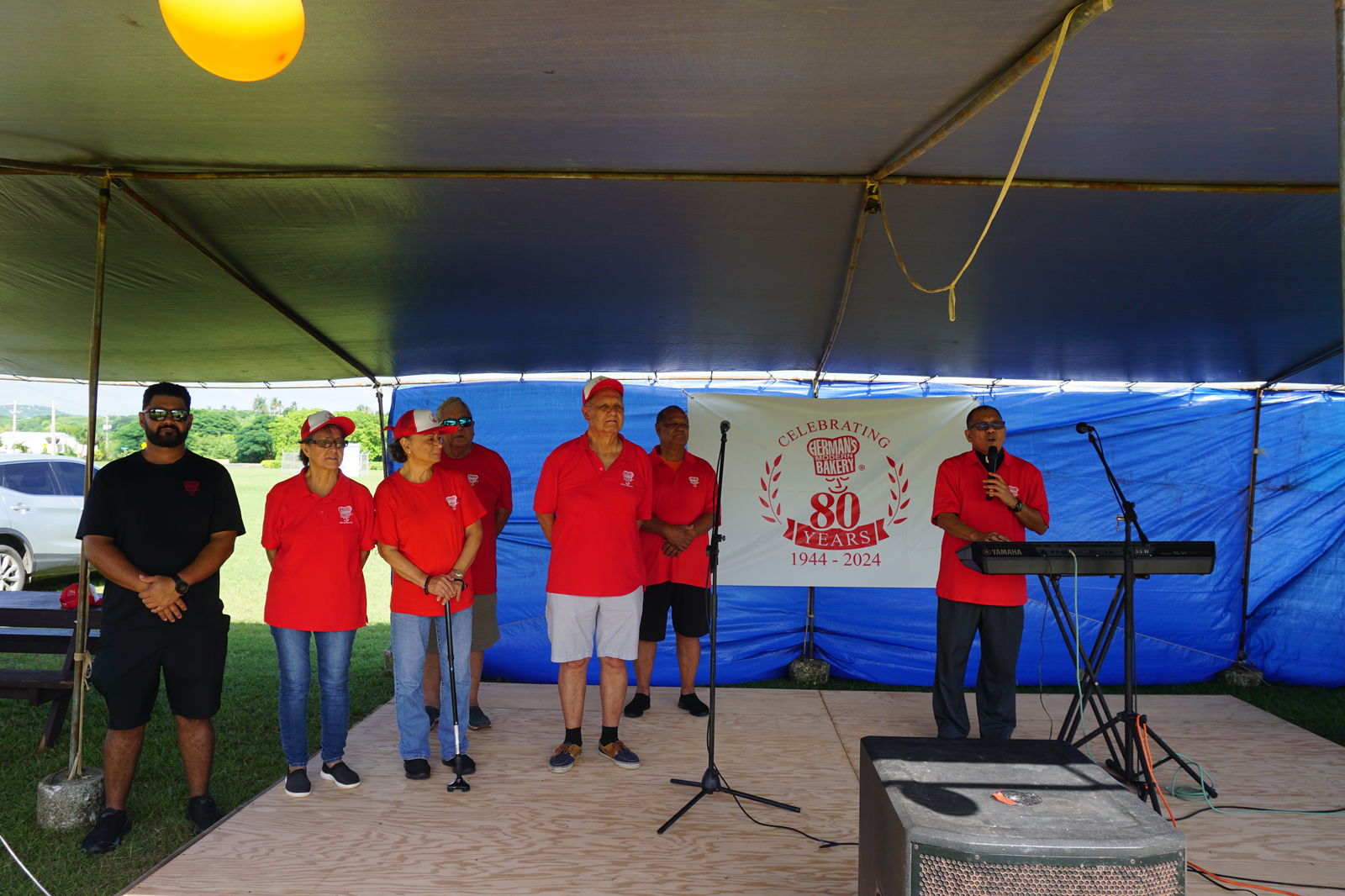 Father Ray, right, leads a prayer with some of the descendants of Herman Guerrero Sr. and Maria Guerrero. Standing first row, right, is Herman “Jun Pan” Guerrero Jr., board president.