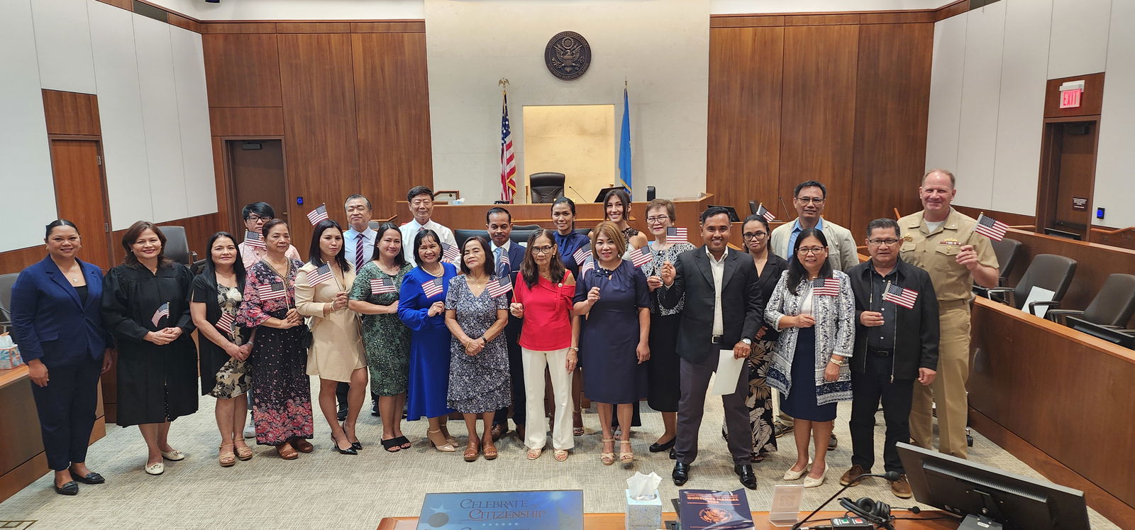 District Court for NMI Chief Judge Ramona V. Manglona, second left, Joint Region Marianas Commander Rear Adm. Brent DeVore, right, and U.S. Citizenship and Immigration Services Officer Maria Camacho, left, pose for a photo with the new U.S. citizens shortly after they were sworn in at the federal courthouse on Thursday.