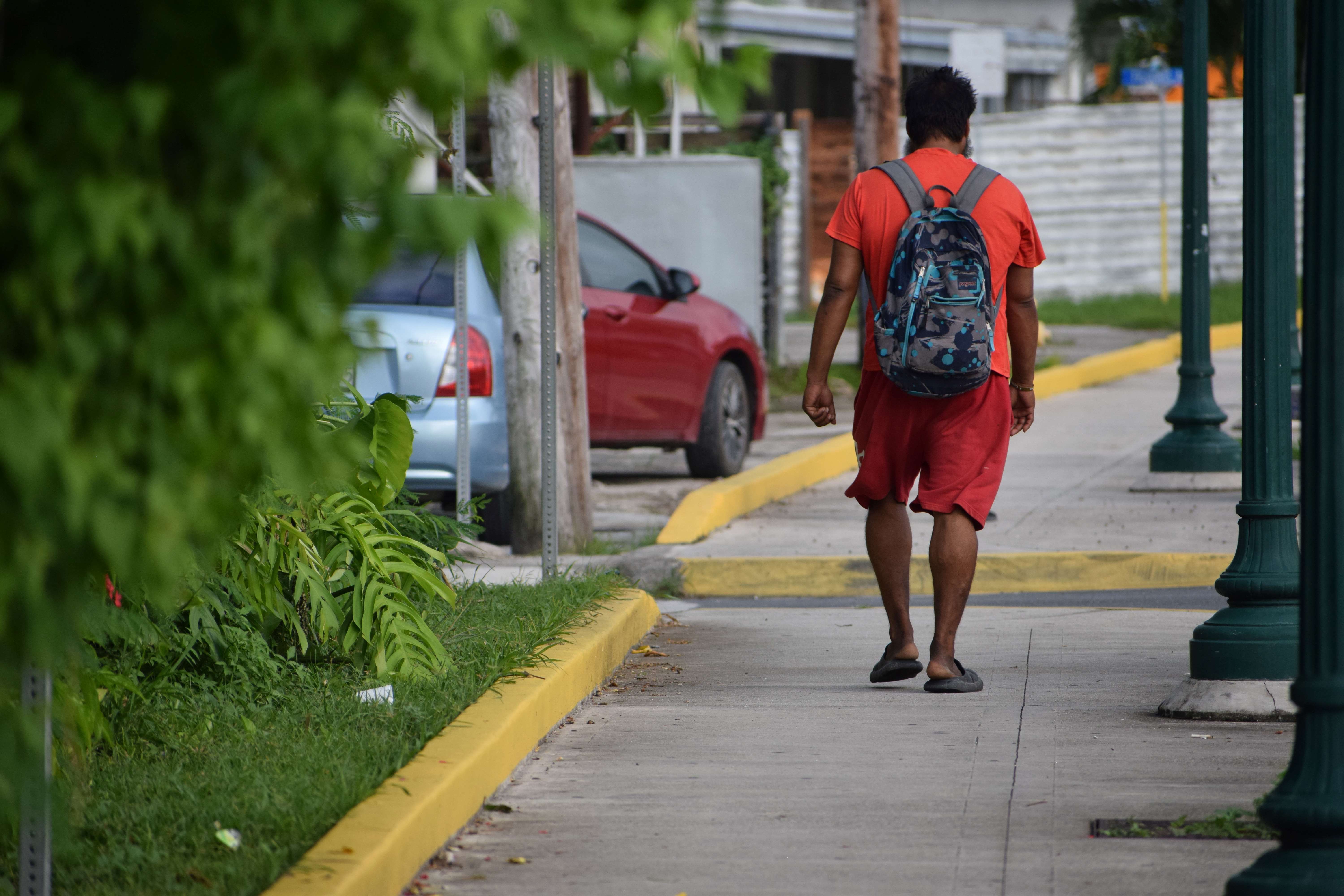 An individual walks away after unsuccessfully asking another person for money in Garapan on Wednesday.