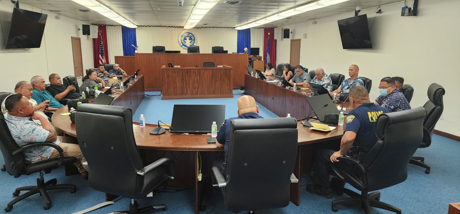 Department of Public Safety Commissioner Anthony Macaranas, center, and Assistant Police Chief Joe Saures field questions from House members during a meeting in the House chamber on Wednesday.