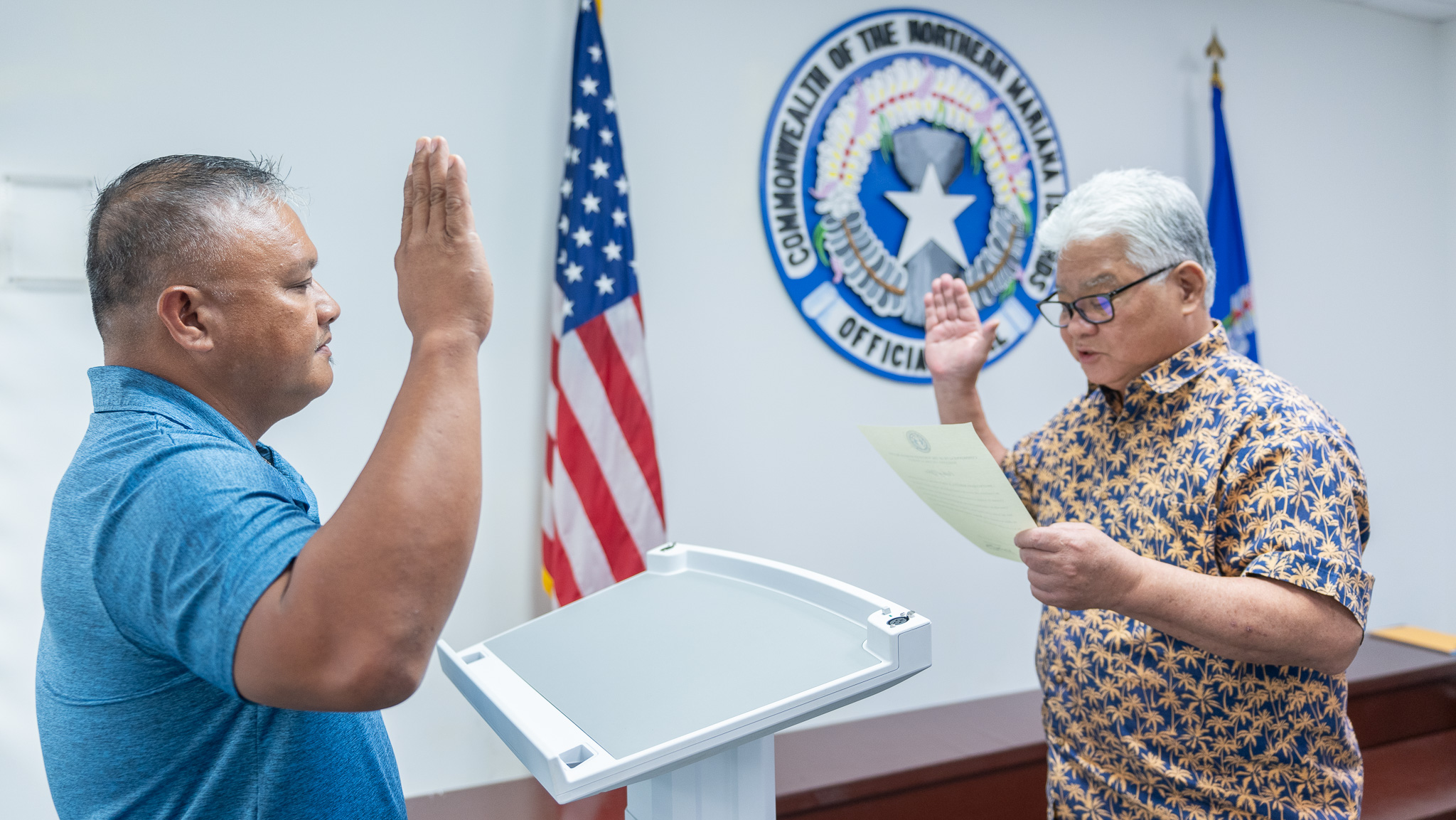 Gov. Arnold I. Palacios, right, swears in Dwayne Lizama Maratita as Marianas Visitors Authority’s board member representing Rota on Friday at the governor’s office.