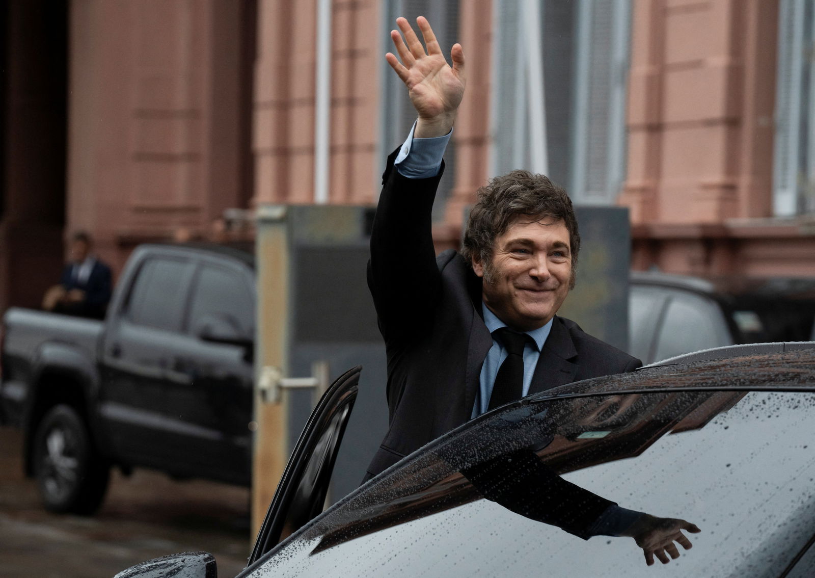 Argentina's President Javier Milei greets from a car after a meeting with his French counterpart Emmanuel Macron at the Casa Rosada presidential palace, in Buenos Aires, Argentina, Nov. 17, 2024.