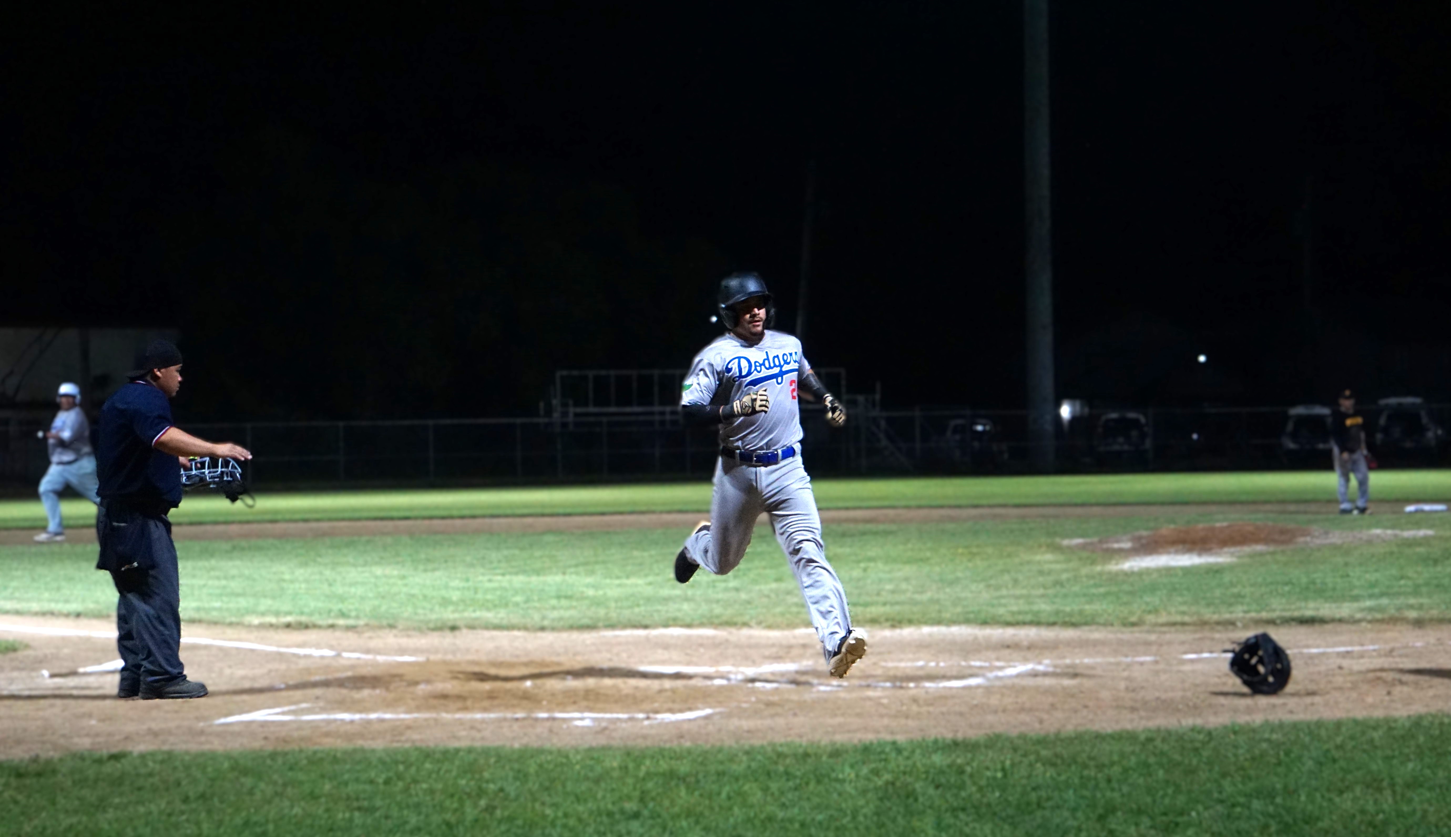 The umpire calls safe as the Dodgers’ Ed Manibusan touches home to score a run during an opening game against the Pirates in the 2024 SBL Masters League at the Francisco “Tan Ko” Palacios Baseball Field on Wednesday.
