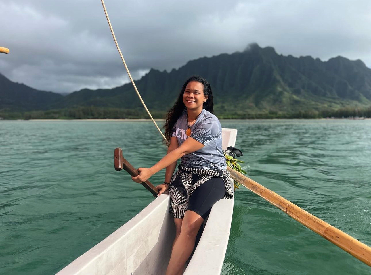 April Repeki, a longtime 500 Sails volunteer, steers the canoe Aunty Oba in Hawaii during the Festival of Pacific Arts and Culture. 