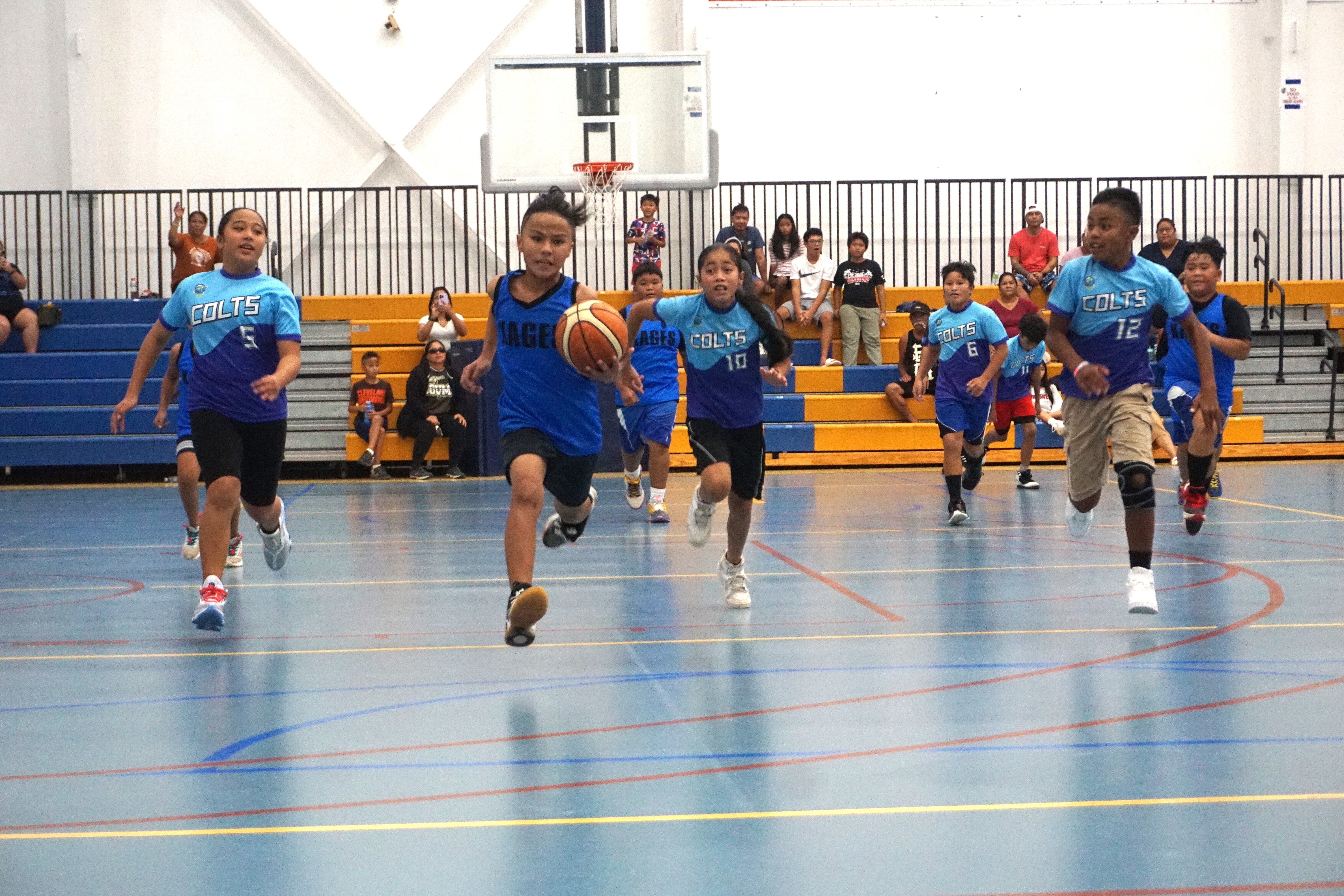 In this file photo, a KAG 1 player dribbles for the fastbreak finish as TIN 1 defenders chase after him during the co-ed elementary school division title game of the IT&E Interscholastic Basketball League SY23-24 at the Marianas High School gym. 