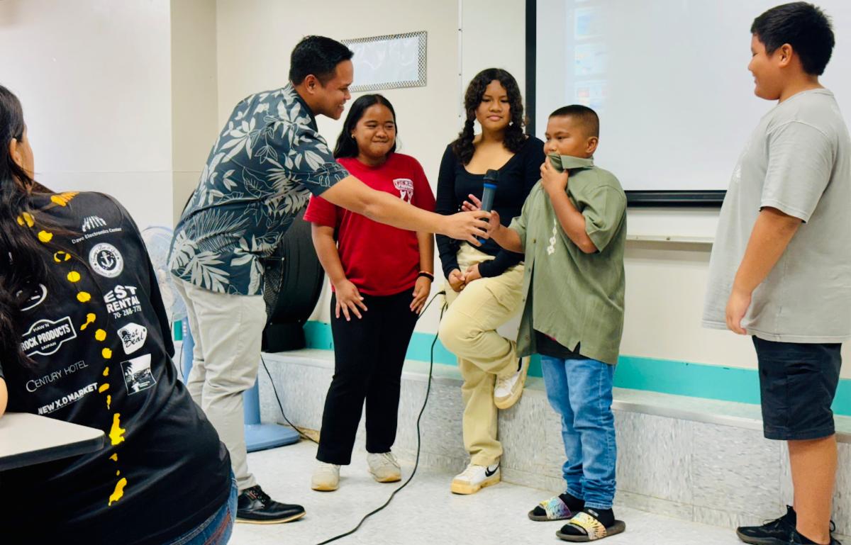 Students of Dandan Middle School Marianas are quizzed by Marianas Visitors Authority Community Projects Specialist Jack Aranda on Oct. 30, 2024, at the school in Dandan, Saipan. Following an educational presentation on The Marianas Tourism industry, the students were able to name how tourism benefits them, various careers in the industry, several signature events organized by MVA, and ways they can support tourism.