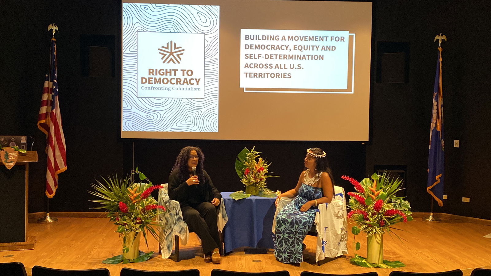 Right to Democracy’s Adi Roman, left, speaks at a community presentation on Tuesday. Joining her on stage is former Rep. Sheila Babauta.  