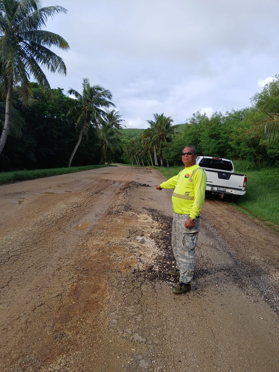 Max Aguon points to a damaged portion of a road that leads to the Bird Island lookout in Marpi.