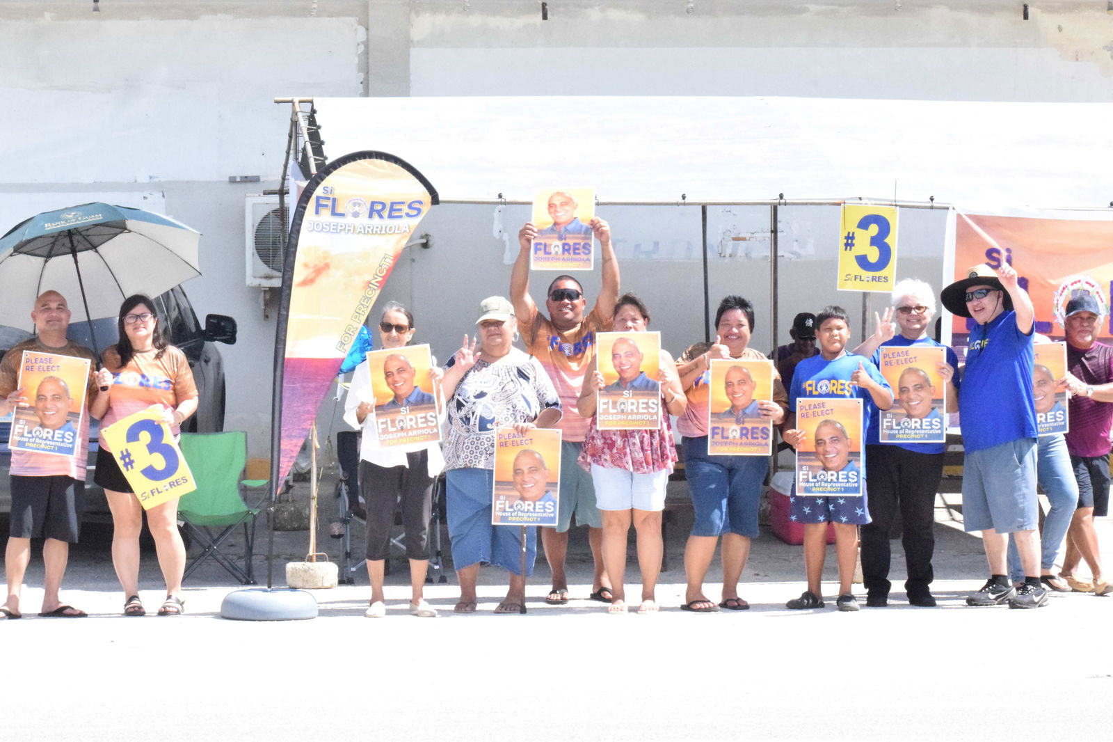 Board of Education member Andrew Orsini, second right, joins the family and supporters of Precinct 1 Rep. Joseph Flores on Beach Road in San Antonio.