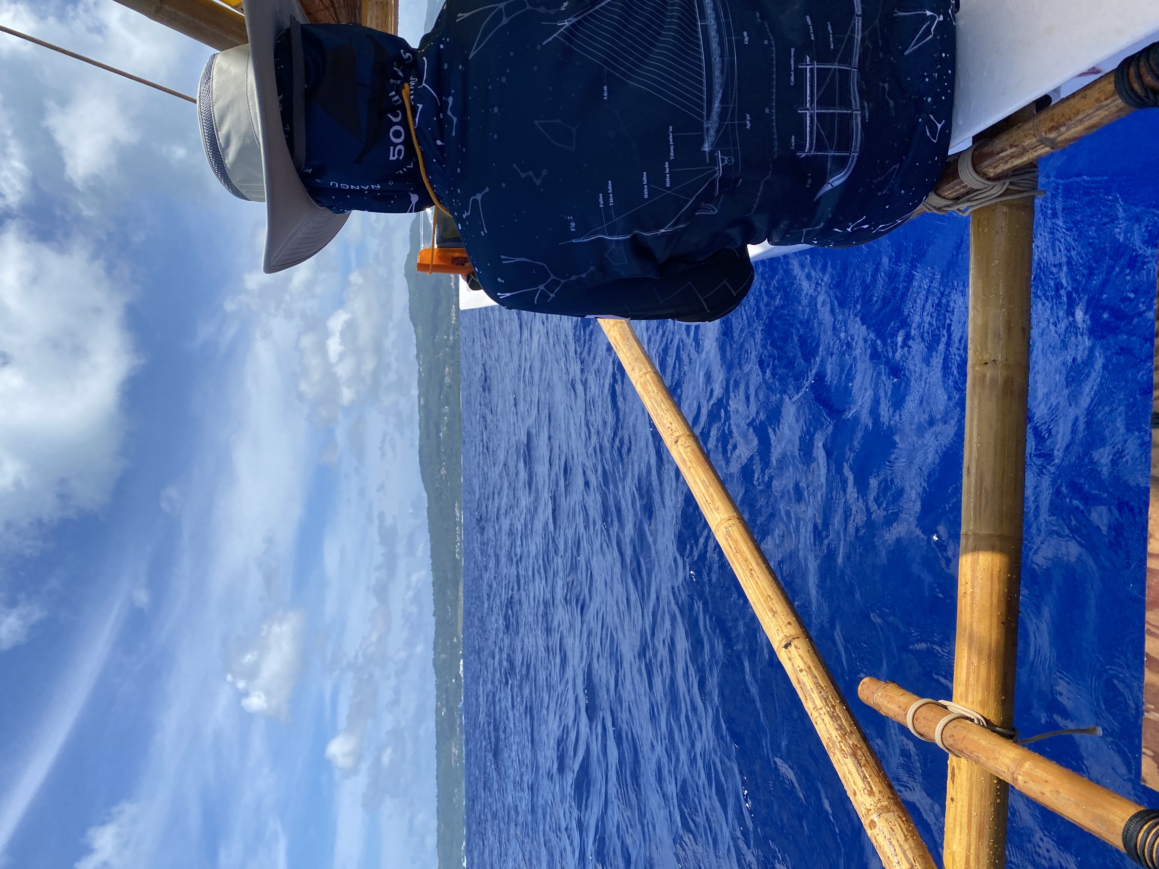 Ellie Roark sits on the gunwale of canoe Aunty Oba while sailing just outside the reef of the Saipan Lagoon.  
