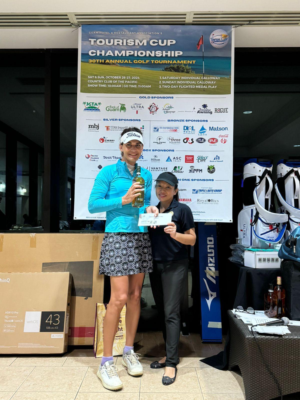 Dominique Kieffer, left, with Guam Hotel & Restaurant Association President Mary Rhodes during the awards ceremony of the 30th Tourism Cup Championship Golf Tournament on Guam. 