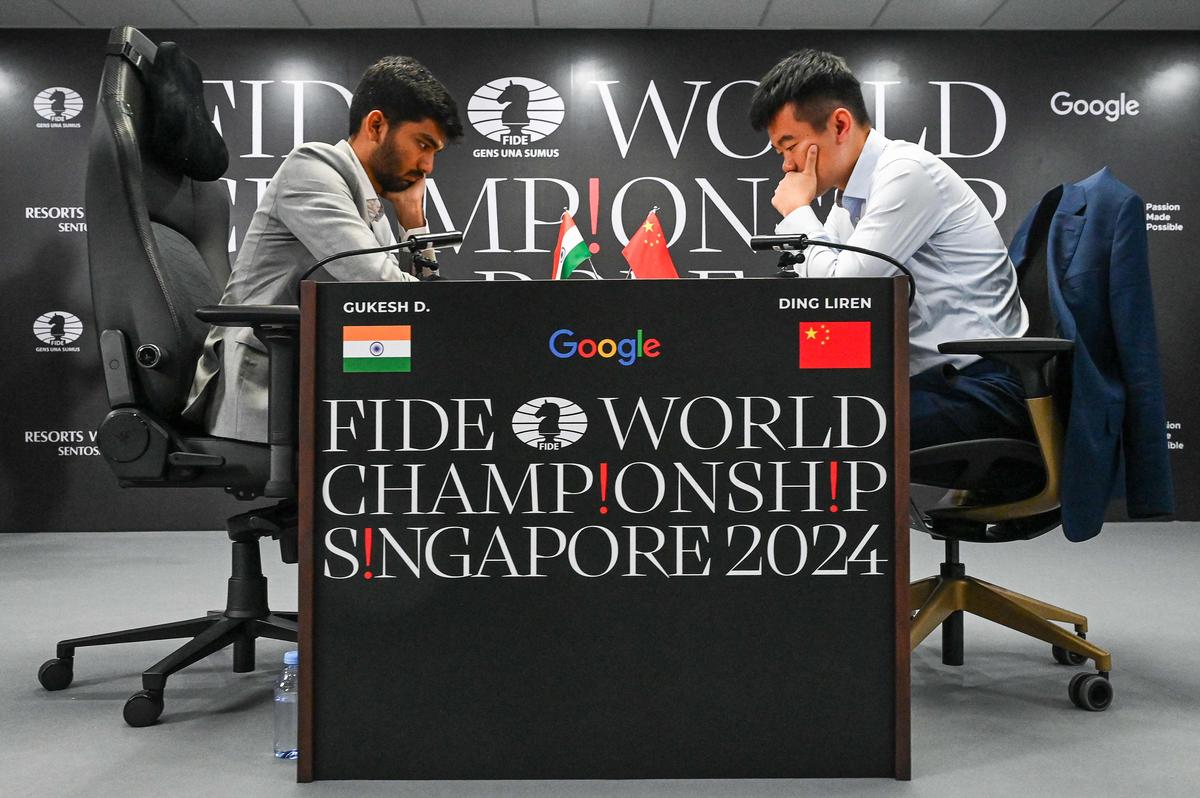 China’s chess grandmaster Ding Liren, right, and India’s chess grandmaster Gukesh Dommaraju, left, compete during the start of the FIDE World Chess Championship in Singapore on Monday, Nov. 25, 2024.