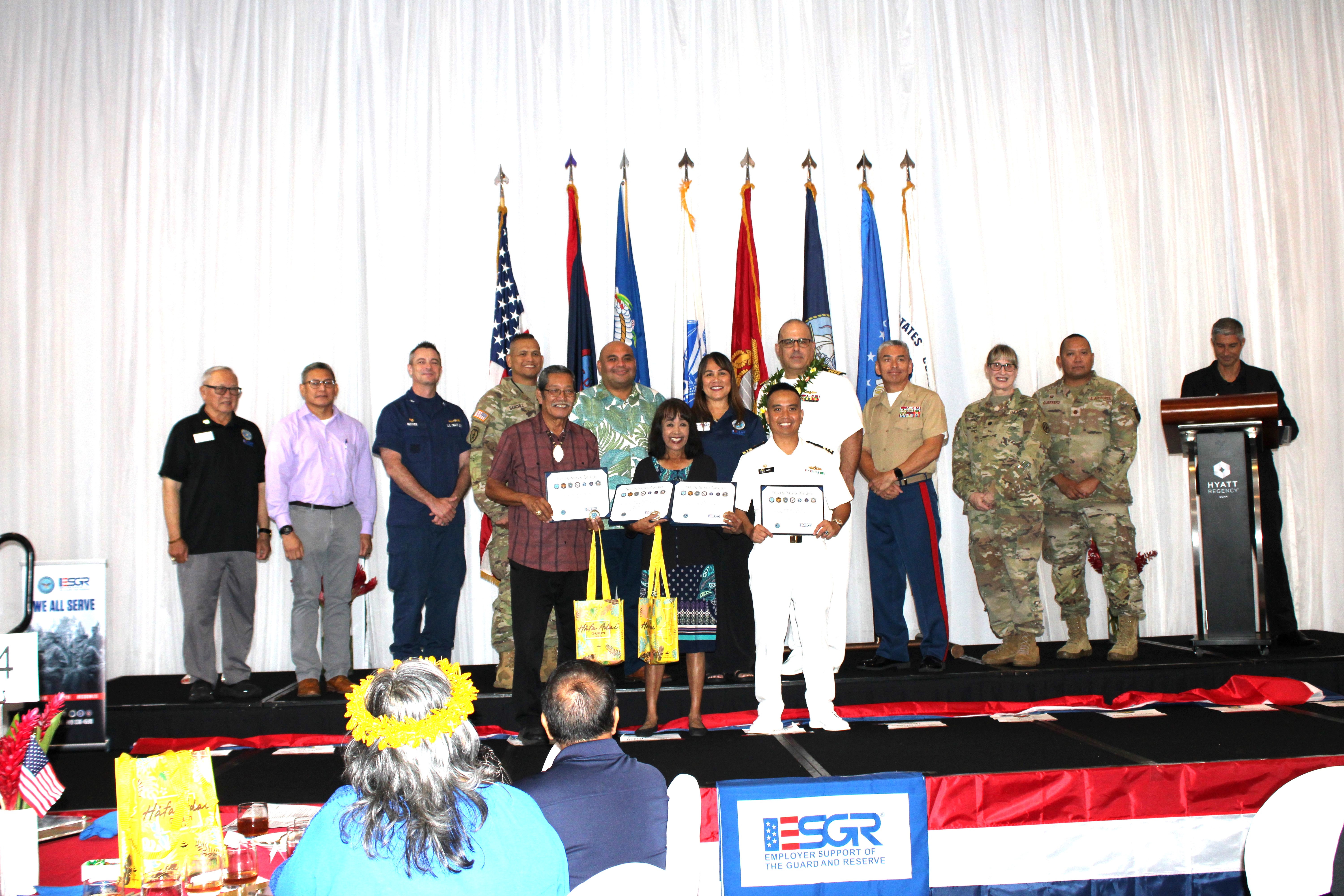 The Seven Seals Award was presented to eight individuals who have went above and beyond in their achievement, initiative, or support of the ESGR mission. Front from left: Senator Joe S. San Agustin, 37th Guam Legislature; Irene Mafnas, Vice President Operations, Guam-CNMI Region; First Hawaiian Bank; Irene Mafnas also received the Seven Seals Award on behalf of Edward Untalan, Executive Vice President and Guam-CNMI Region Manager First Hawaiian Bank on his behalf since he was not able to attend; and Lieutenant Commander Brian Matic, Commanding Officer, U.S. Navy Reserve Center, Guam.  The following individuals have previously received their Award or arrangements have been made: General Mark W. Siekman, Commanding General, 9th Mission Support Command, U.S. Army Reserve; Captain Nicholas Simmons, Commanding Officer, U.S. Coast Guard Forces Micronesia Sector Guam; Vickie Izuka, Vice President and Saipan Area Manager, First Hawaiian Bank; and Daniel Aquino, Special Assistant, Commonwealth Bureau of Military Affairs. Back, from left: Retired U.S. Army Major General Benny M. Paulino, GU-CNMI Vice Chair; Lieutenant Colonel Victor Balajadia, Director of Staff, Guam Air National Guard; Captain Robert Kistner, U.S. Coast Guard; Lieutenant Colonel Romeo Sanchez, 1st-294th Infantry Battalion, Guam Army National Guard; Acting Governor Joshua Tenorio; CathyAnn C. Gogue, GU-CNMI State Chair; U.S. Navy Captain Craig S. Der Ananian, Navy Readiness and Mobilization Command, San Diego; Colonel Ernest Govea, Commanding Officer, Marine Corps Base Camp Blaz, U.S. Marine Corp.; Lieutenant Colonel Penny Sima, U.S. Army Reserve; and Major Benjamin Guerrero, U.S. Air Force Reserve.