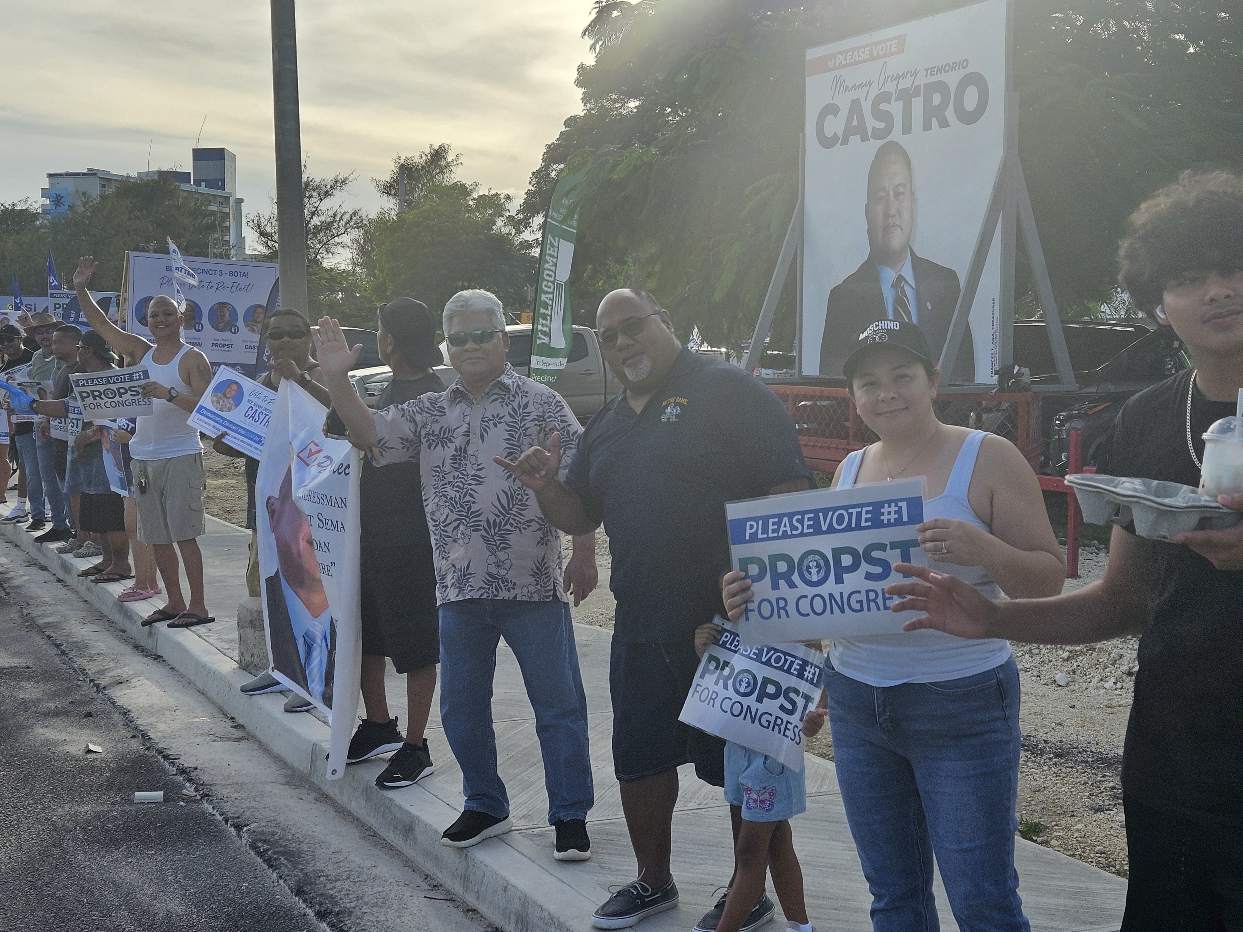 Gov. Arnold I. Palacios joins Independent-Democrat candidates and supporters, including House counsel Joe Taijeron and wife Jamika, in a roadside waving event on Beach Road in Susupe.