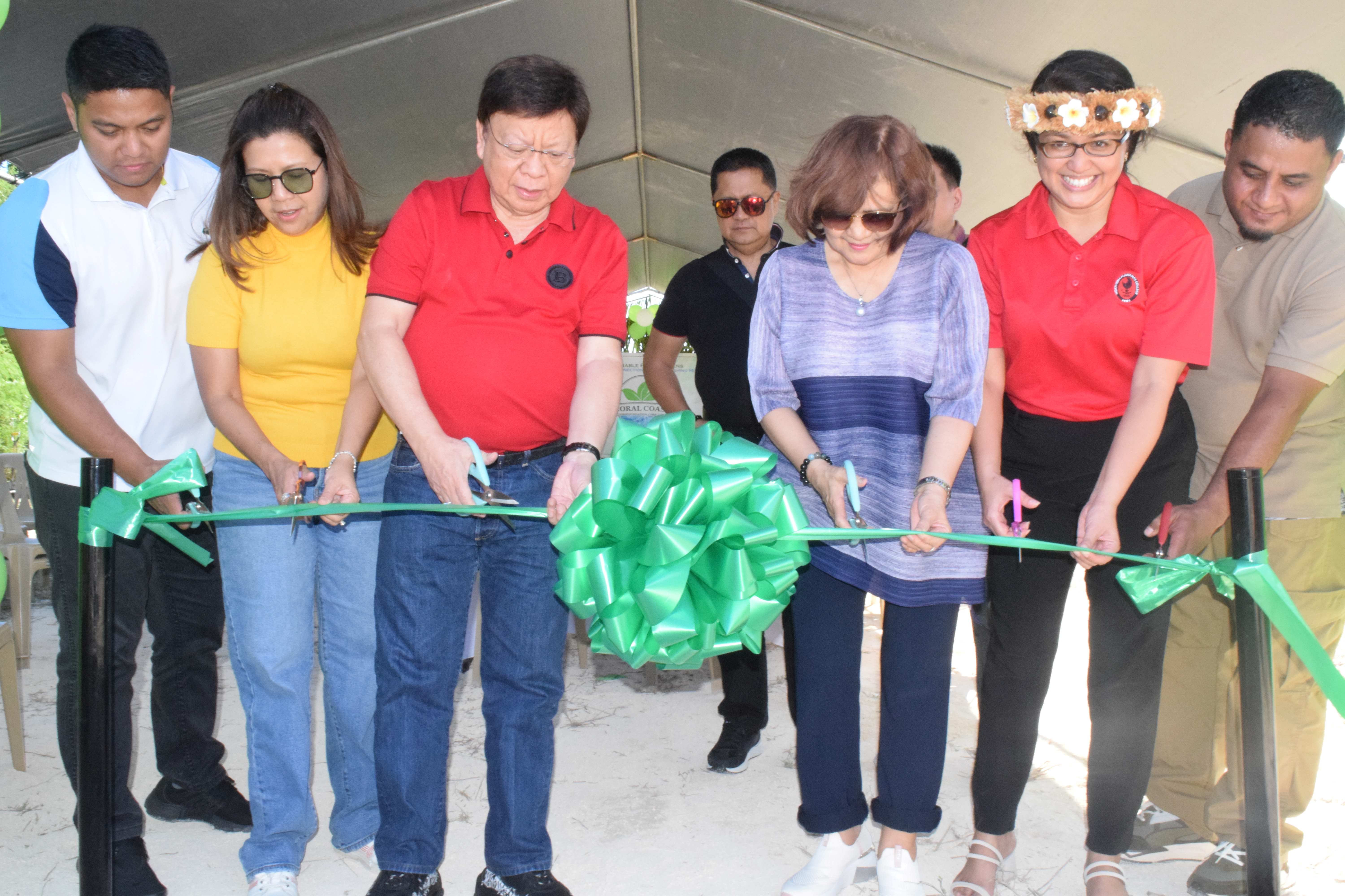 Philippine Congressman Rodante Marcoleta, third left, his wife, Edna third right, Northern Marianas College-Cooperative Research, Extension and Education Services Interim Dean Patricia Coleman, second right, Division of Agriculture federal program coordinator Charles Aiseam, right, Coral Coast Foundation Corp. Director Eleanor Alinas, second right, and husband Maverick Rotap cut the ceremonial ribbon to launch the Sustainable Fresh Greens project in Koblerville on Thursday.