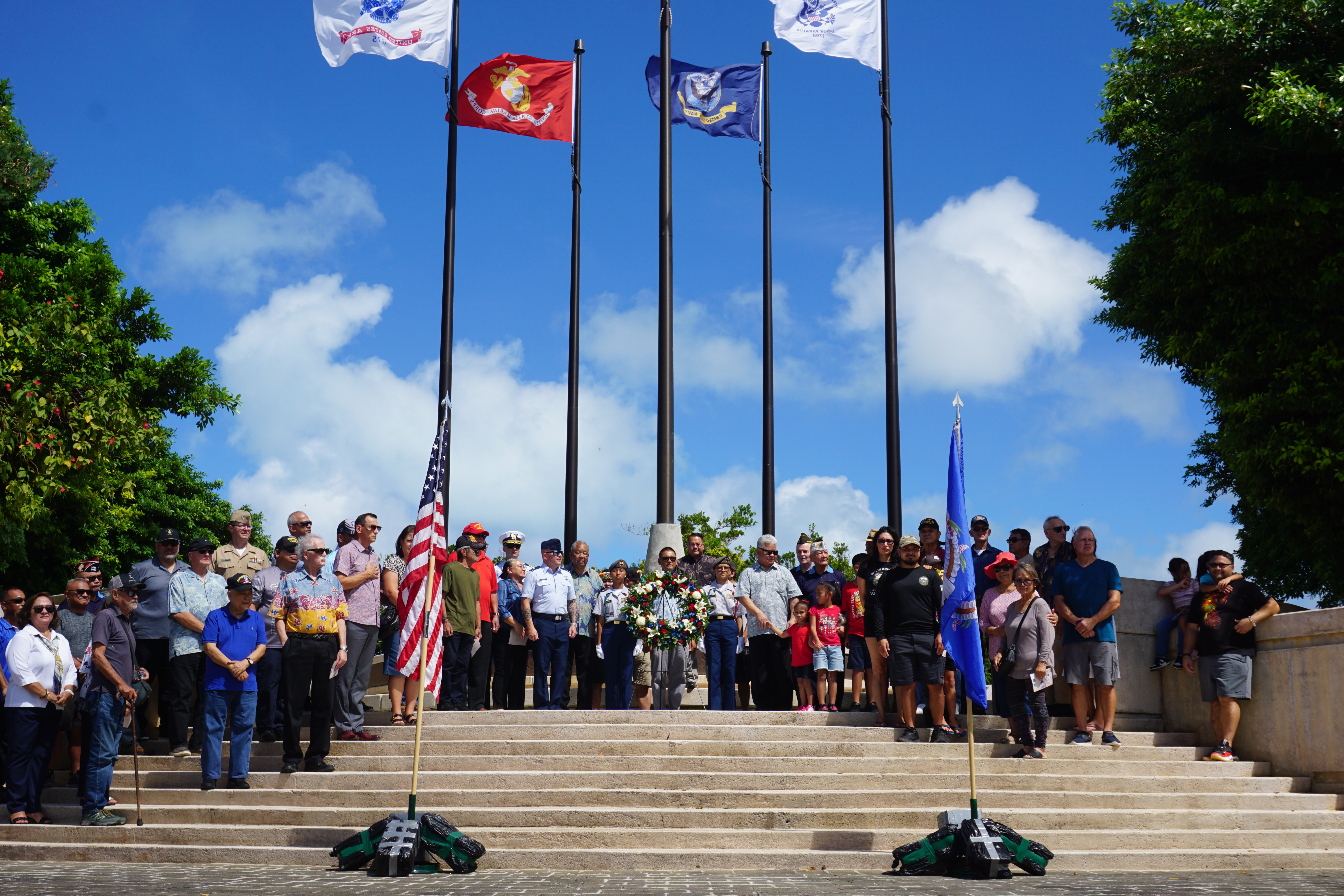 Gov. Arnold I. Palacios, Lt. Gov. David M. Apatang and other officials pose for a photo with veterans and other members of the community at American Memorial Park’s Court of Honor on Veterans Day, Monday, Nov. 11, 2024.